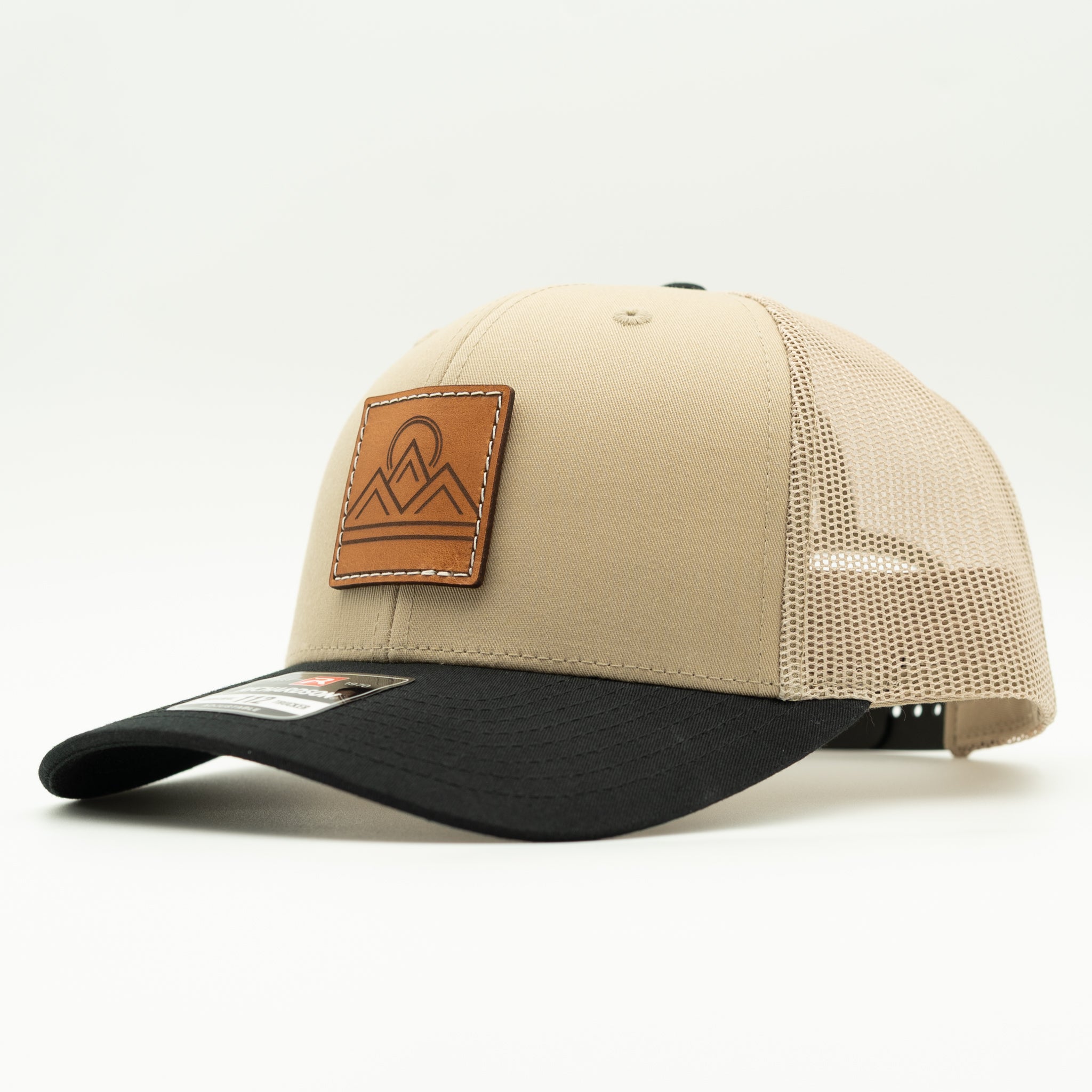 Side view of Lunar Ridge khaki and black combo Richardson 112 leather patch mountain hat with black mesh