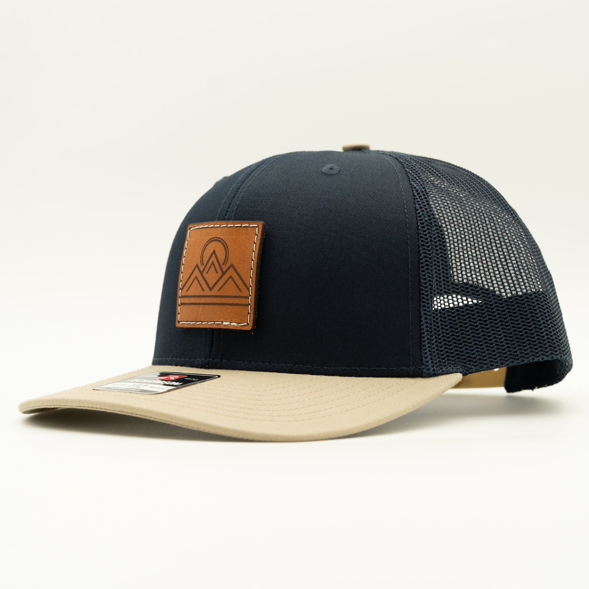 Side view of Lunar Ridge navy and khaki combo Richardson 112 leather patch mountain hat with khaki mesh