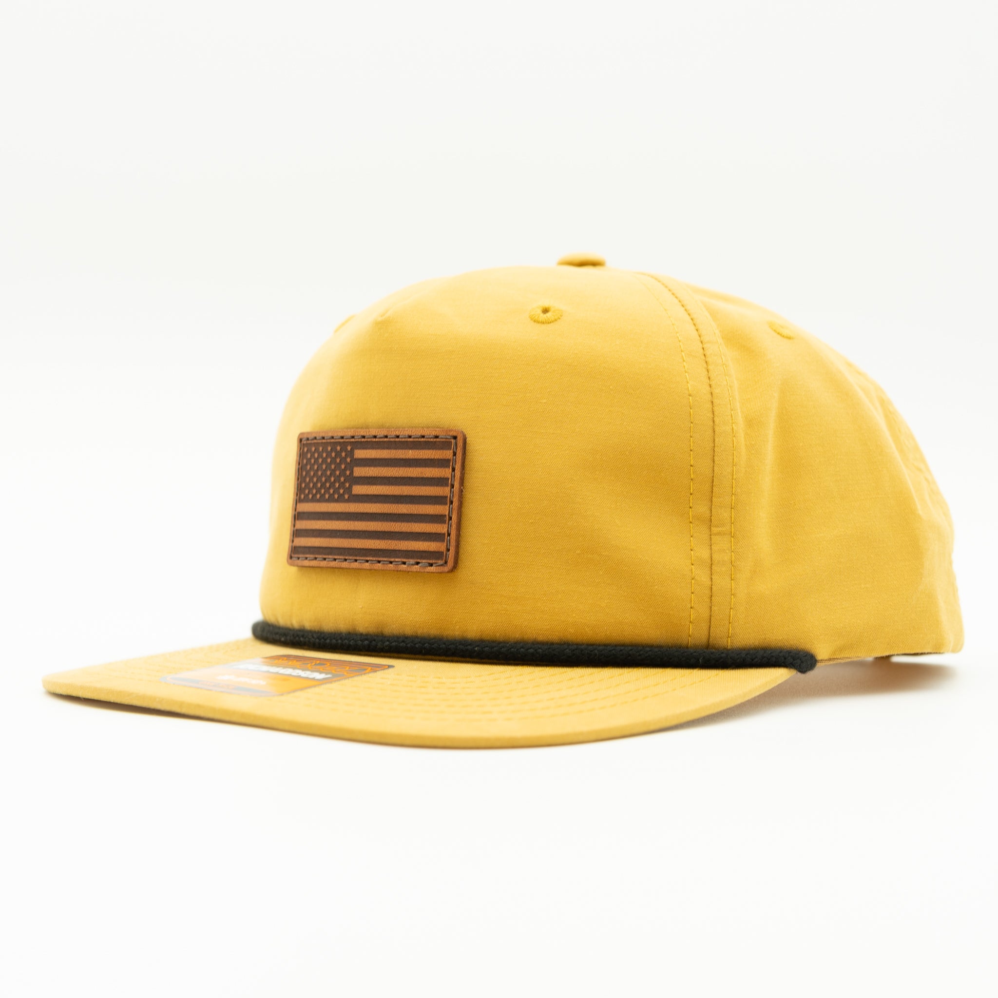 Side profile of biscuit Richardson 256 American flag rope hat with light brown leather patch.
