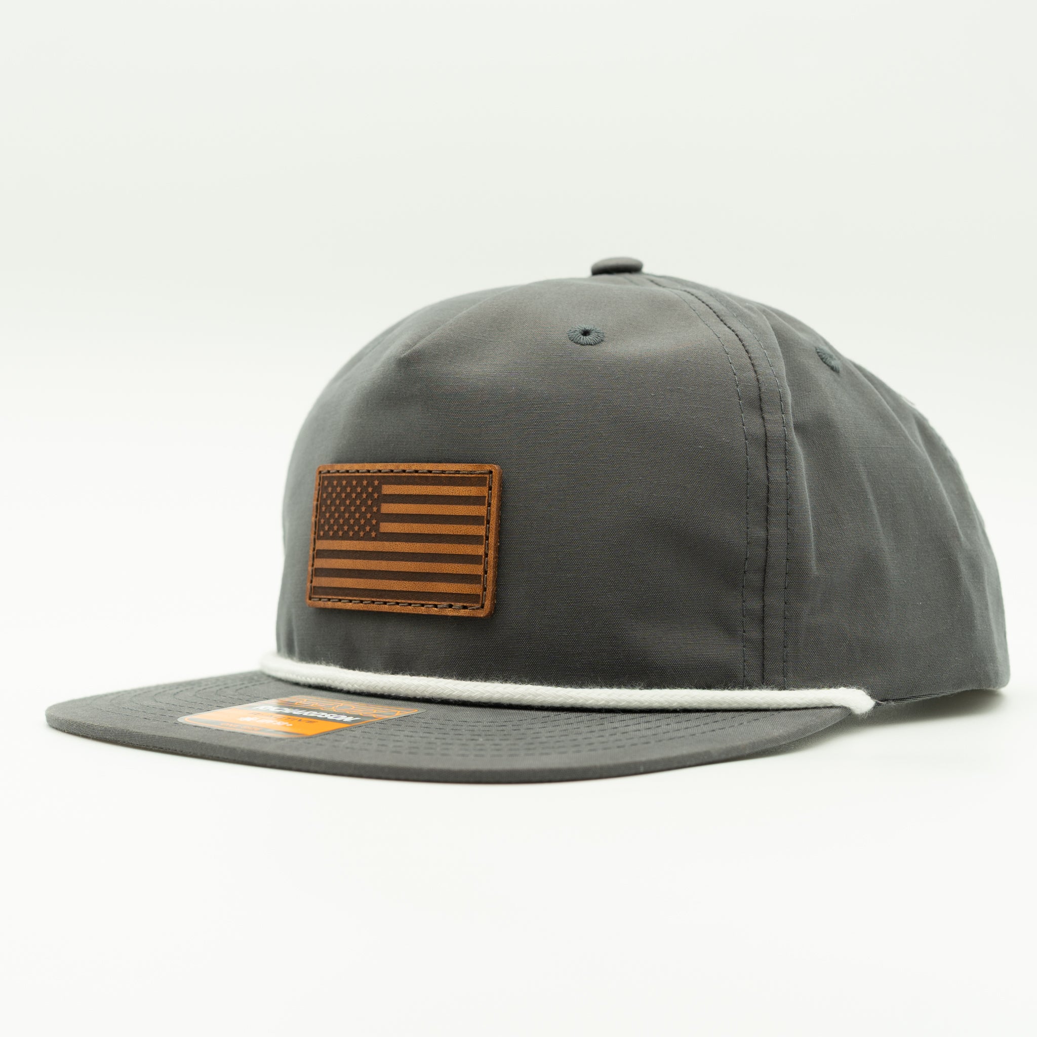 Side view of charcoal Richardson 256 American flag rope hat with light brown leather patch.