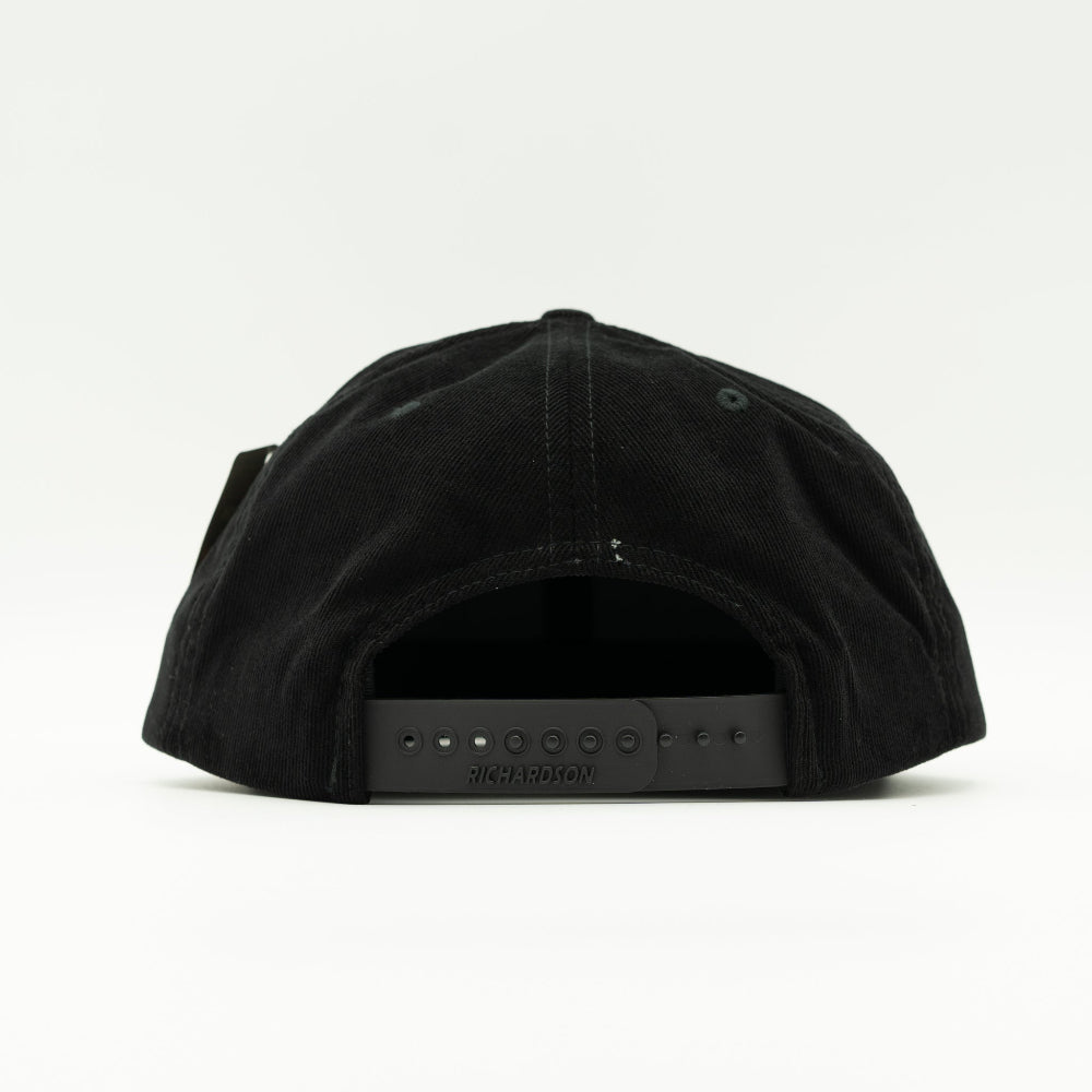 Back view of black Richardson 253 Moonlite Mountain hat, showing corduroy panels and adjustable snapback closure on a high-profile flat bill mountain hat.