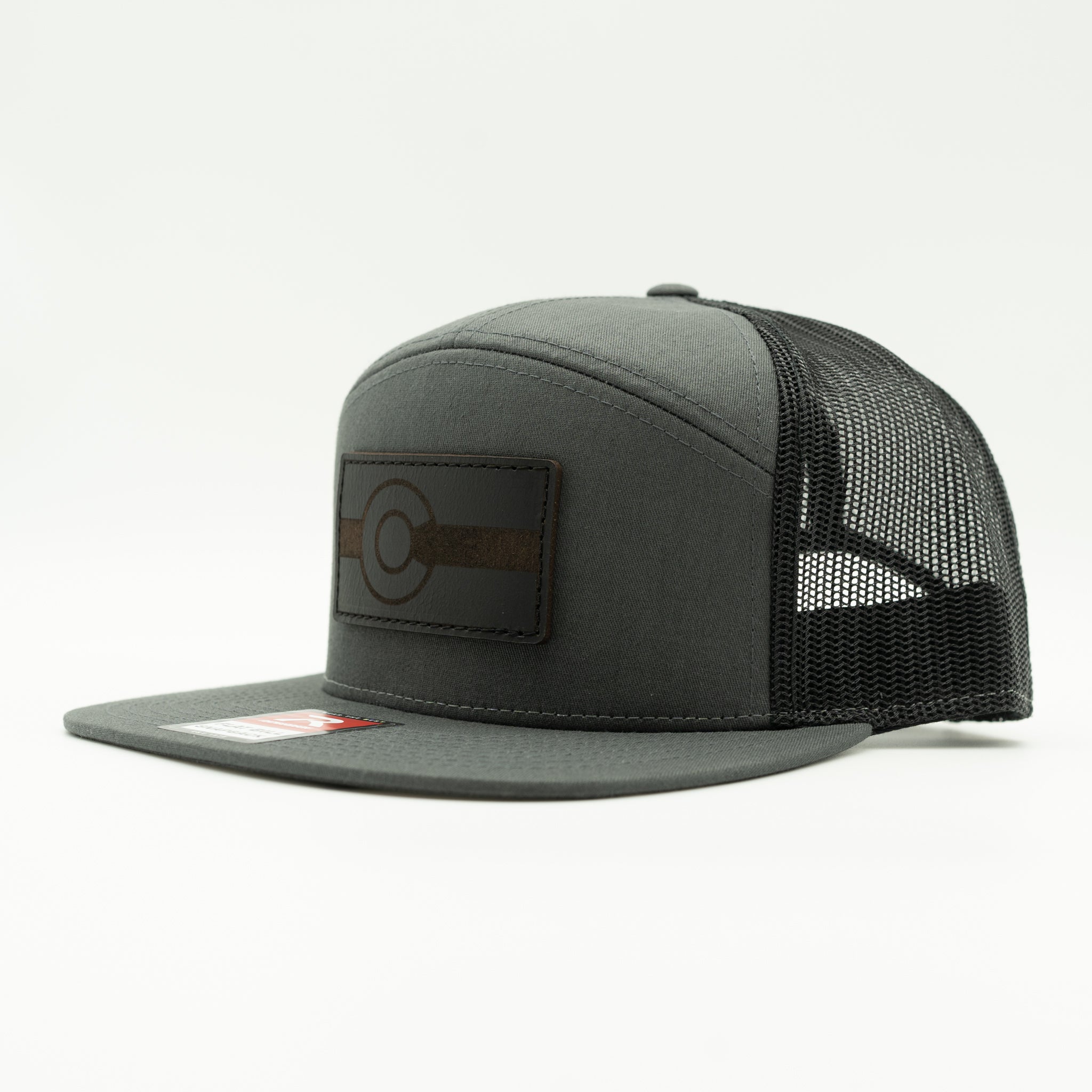Side view of charcoal and black Richardson 168 seven panel hat with black leather Colorado flag patch, Colorado flag leather patch trucker