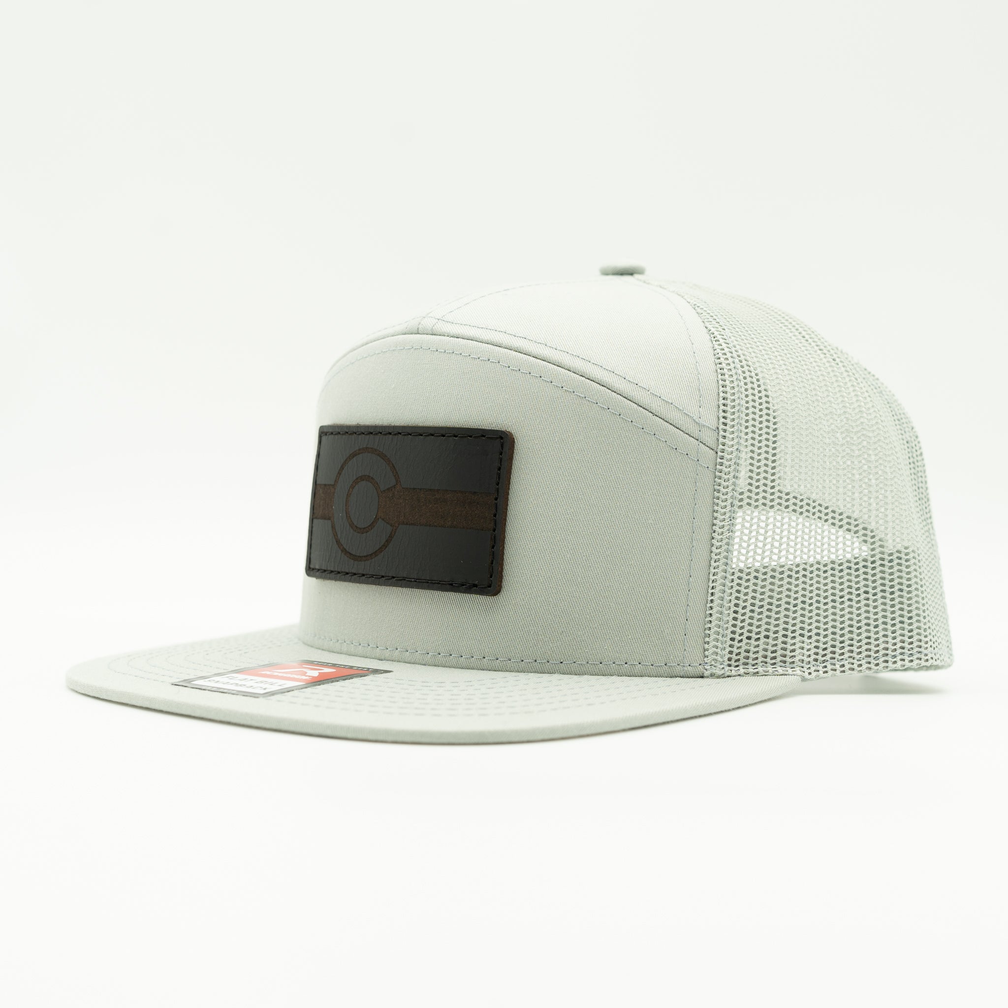 Side view of quarry gray Richardson 168 seven panel hat with black leather Colorado flag patch, Colorado flag leather patch trucker