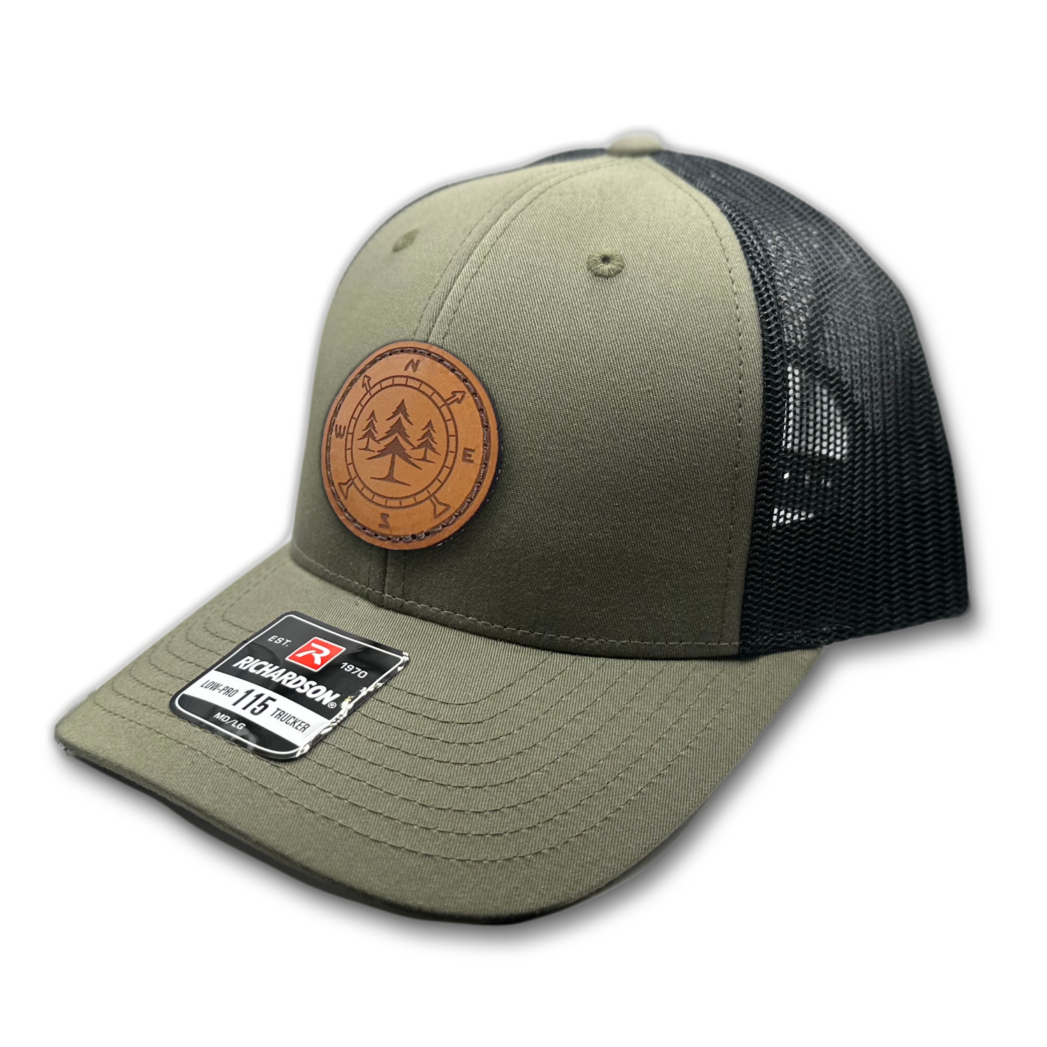 A premium custom leather patch hat named Lost Pines, showcasing a distinctive compass and pine trees design on a circle patch. Handcrafted in the USA, this unique hat features authentic leather stitching on a Loden Green/Black Richardson 115 low profile SnapBack hat. Available in small and m/l sizes in a variety of colors, this hat is inspired by the scenic mountains of Colorado. Perfect for hat enthusiasts seeking high-quality custom leather patch designs.