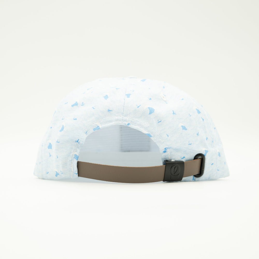 A light blue and white patterned baseball cap viewed from the back, featuring a brown adjustable strap with a black plastic buckle.
Color: Blue Wave