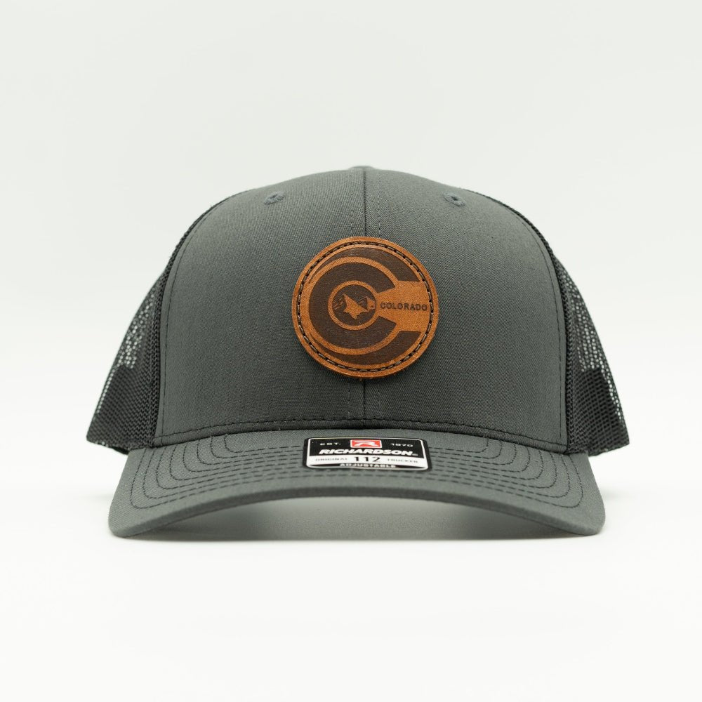 Front view of charcoal and black Richardson 112 mid-profile hat featuring round veg-tan leather Colorado flag patch and pre-curved visor.
Color: Charcoal/Black