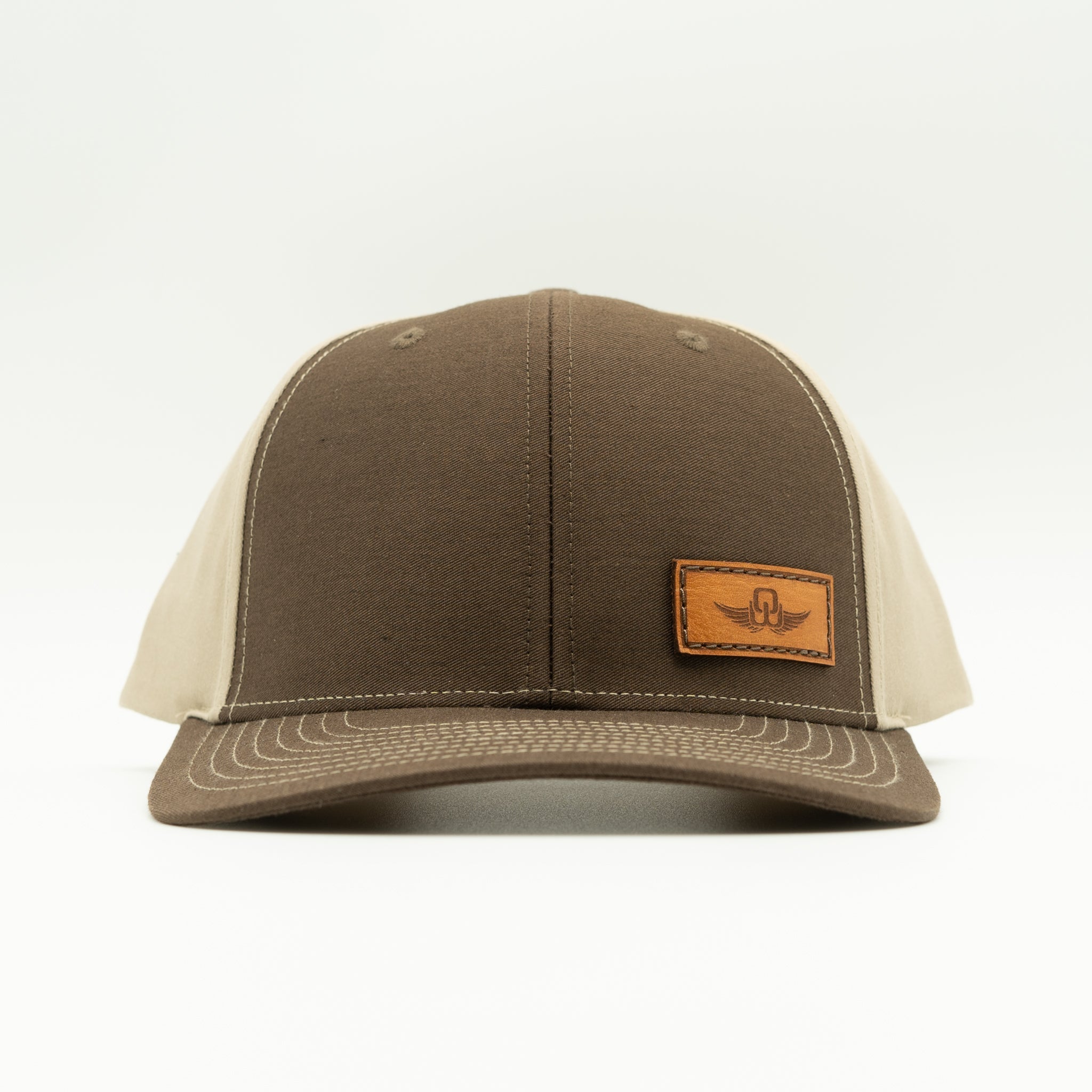 Front view of brown/khaki Richardson 312 full-fabric snapback with sewn real leather Spread Your Wings patch.