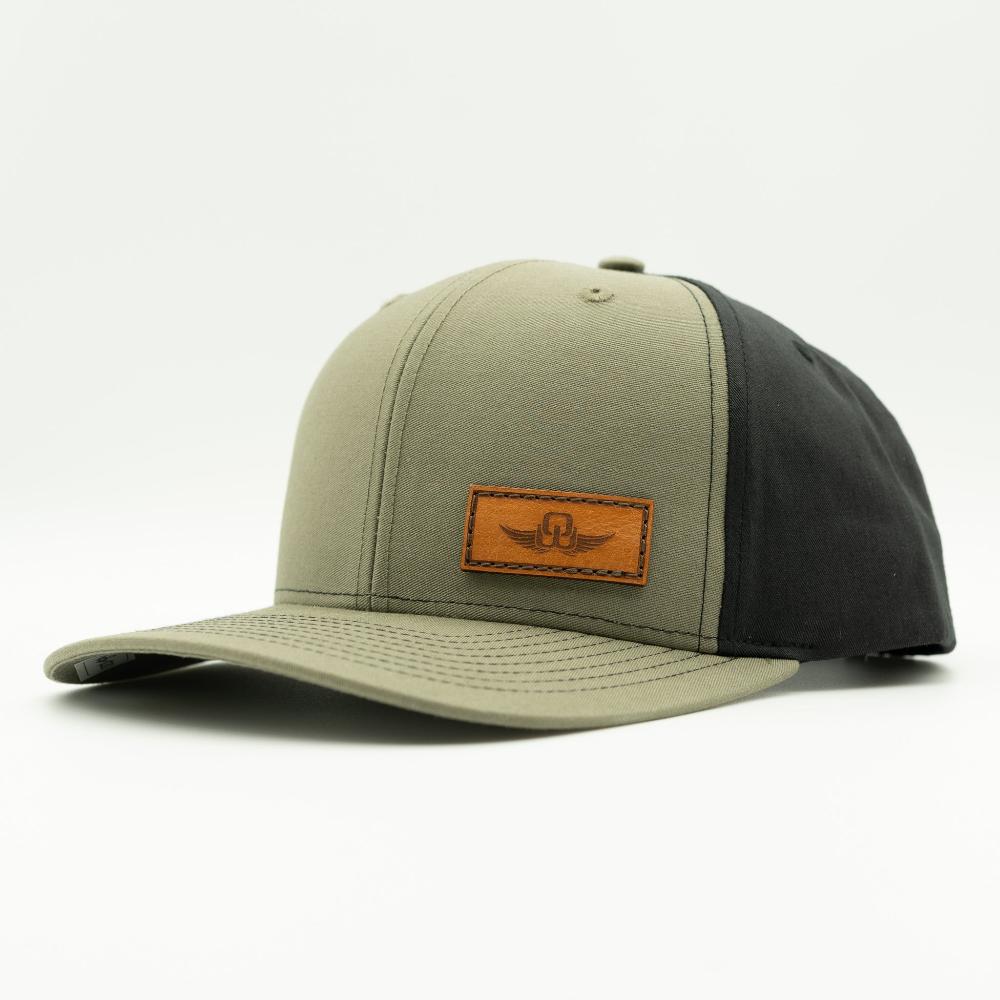 Side view of loden/black Richardson 312 hat with Spread Your Wings leather patch, curved visor, outdoor snapback style.