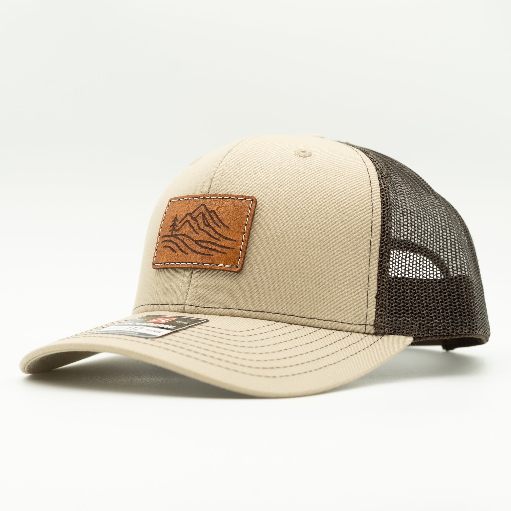 Side view of khaki and brown Richardson 112 Driftline leather patch hat, neutral mountain trucker for trail or town.
Color: Khaki/Coffee