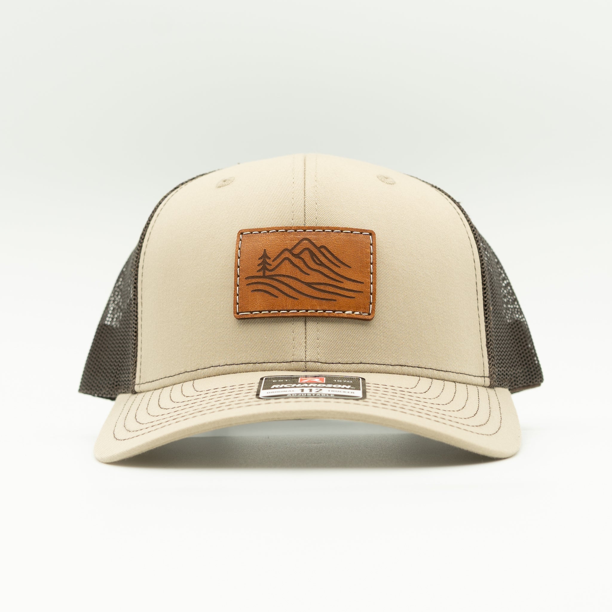 Front view of khaki and brown Richardson 112 Driftline hat with engraved veg-tan leather mountain range patch
Color: Khaki/Coffee