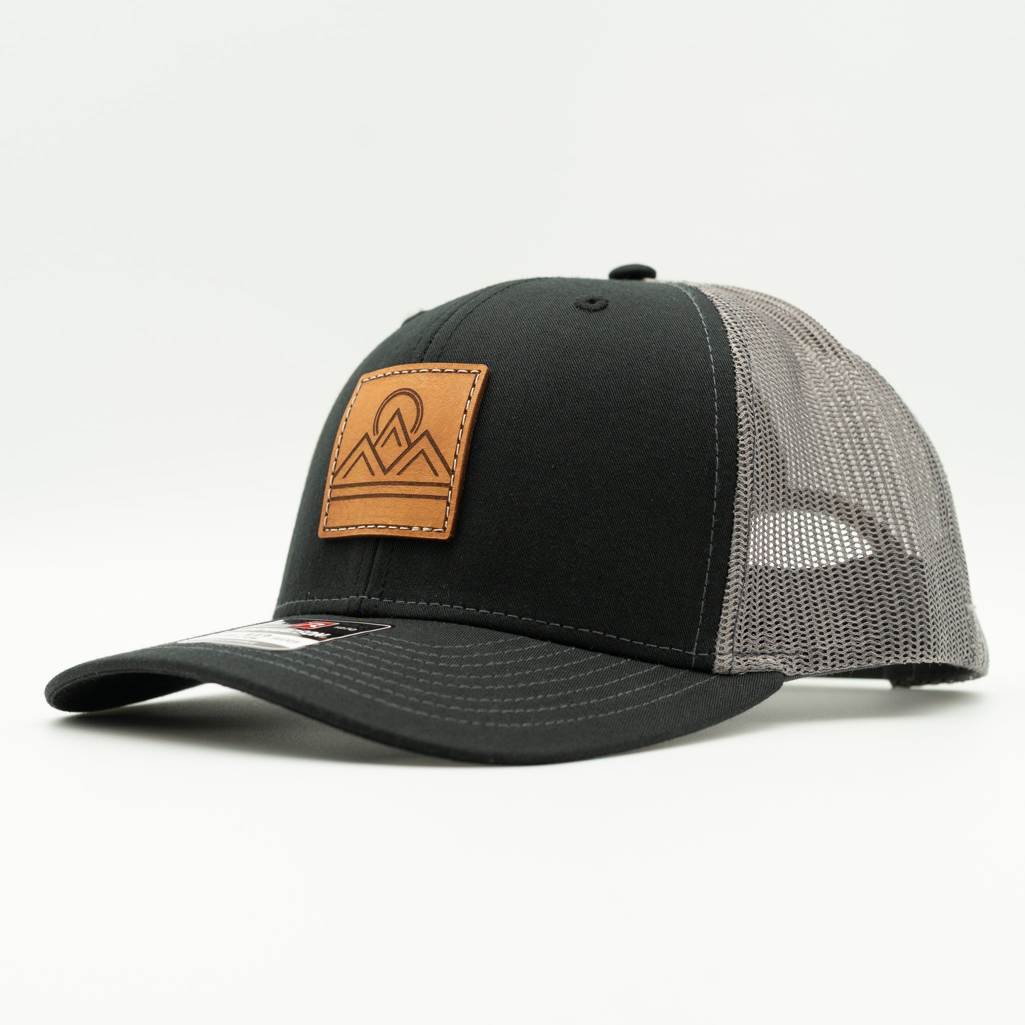 Side view of Lunar Ridge black and charcoal Richardson 112 leather patch mountain hat with black mesh back
Color: Black/Charcoal