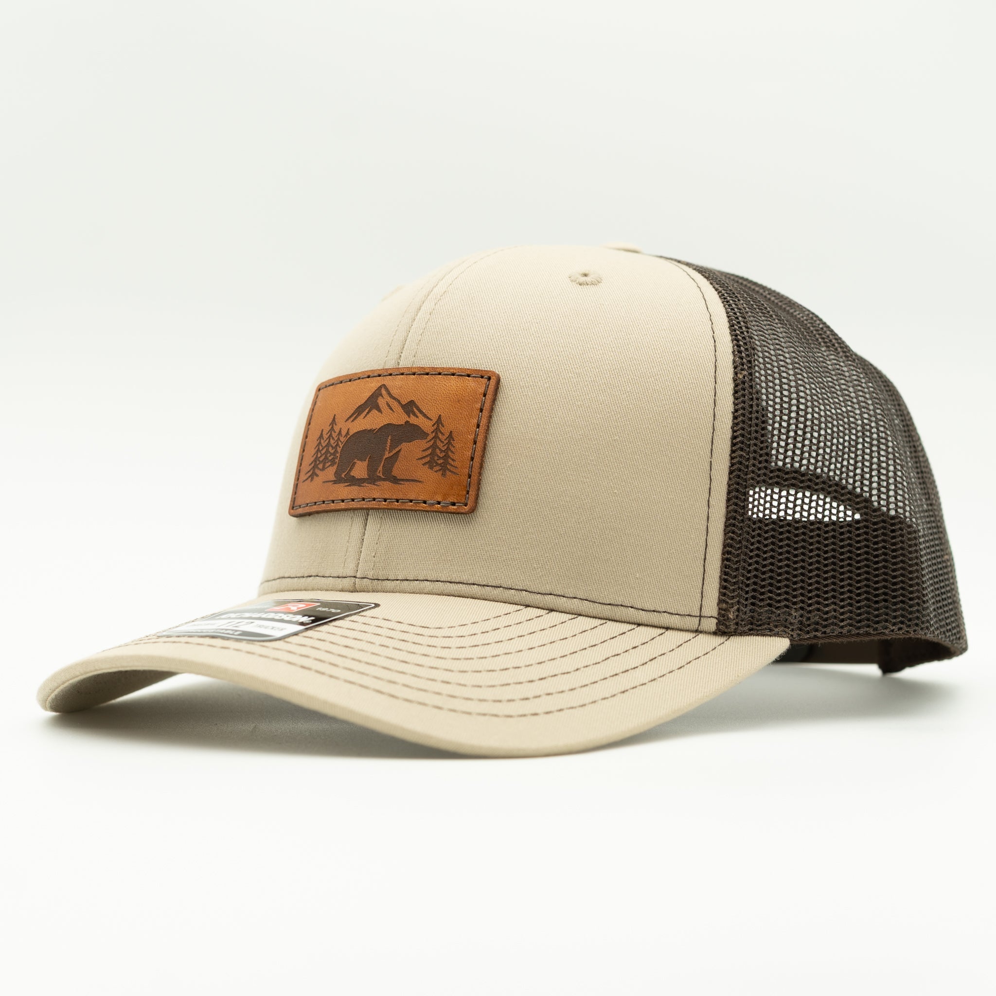 Side view of Bearline Peak leather patch hat on khaki and brown Richardson 112, showing mid profile crown, engraved leather patch, and mesh back.
Color: Khaki/Coffee