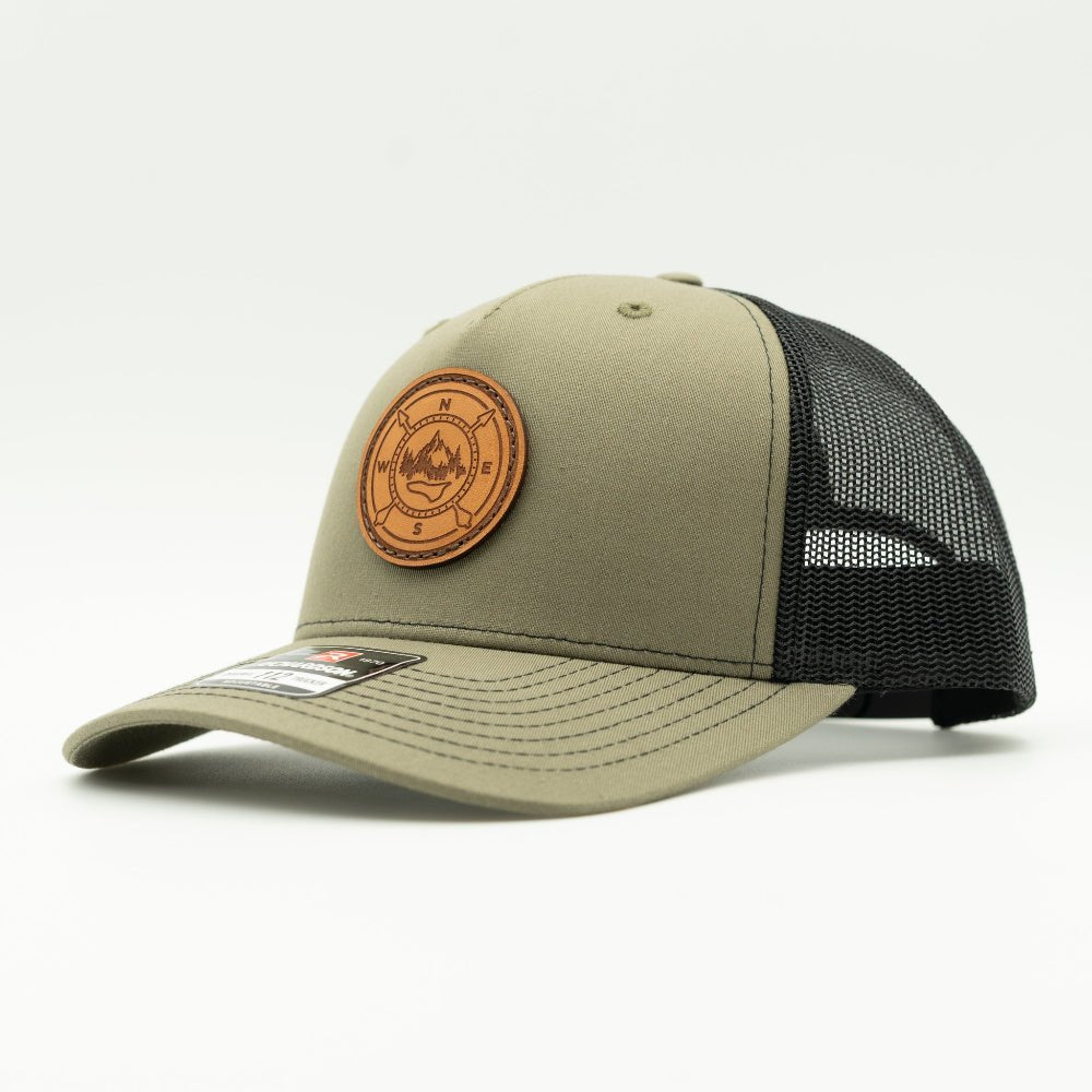 Loden and black Richardson 112FP compass leather patch hat, side angle, mesh back trucker with snapback closure