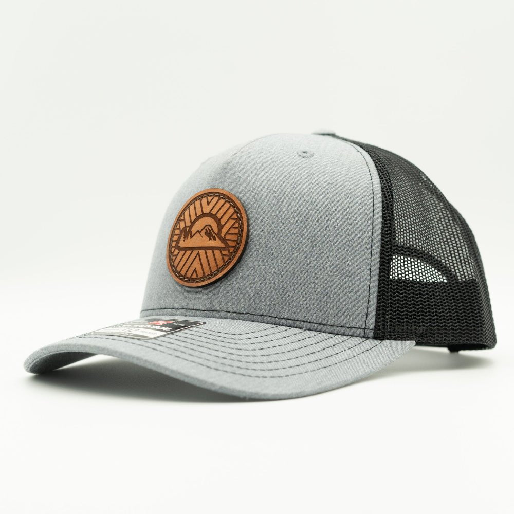 Side view of heather grey/black Richardson 112FP Mosaic Sunset leather patch trucker hat with mesh back and snapback.
Color: Heather Grey/Black