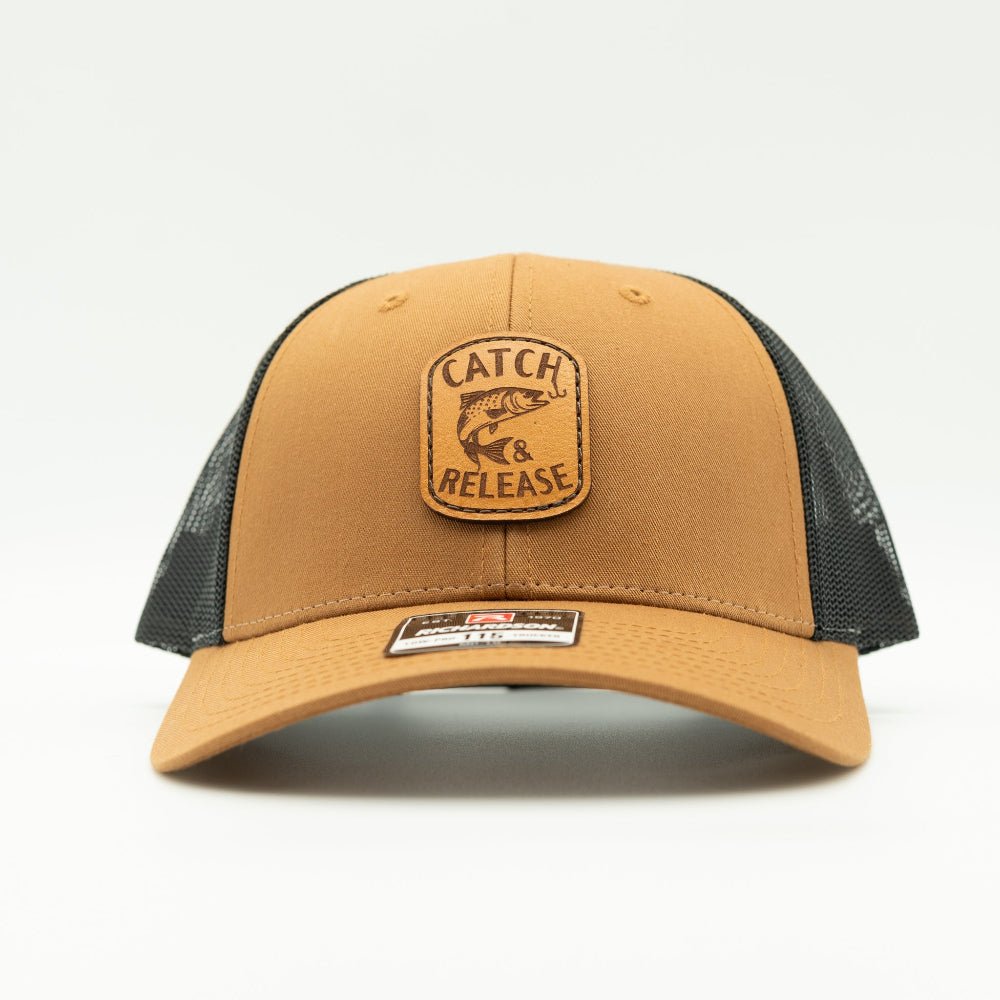 Front view of caramel Richardson 115 low profile trucker hat with Catch & Release fish and hook leather patch.
Color: Caramel/Black