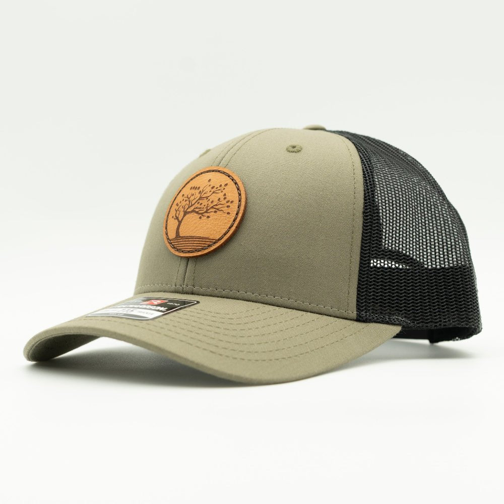 Side angle of Loden Black Richardson 115 low profile hat, olive front with black mesh and sewn Blossom leather patch.
Color: Loden/Black