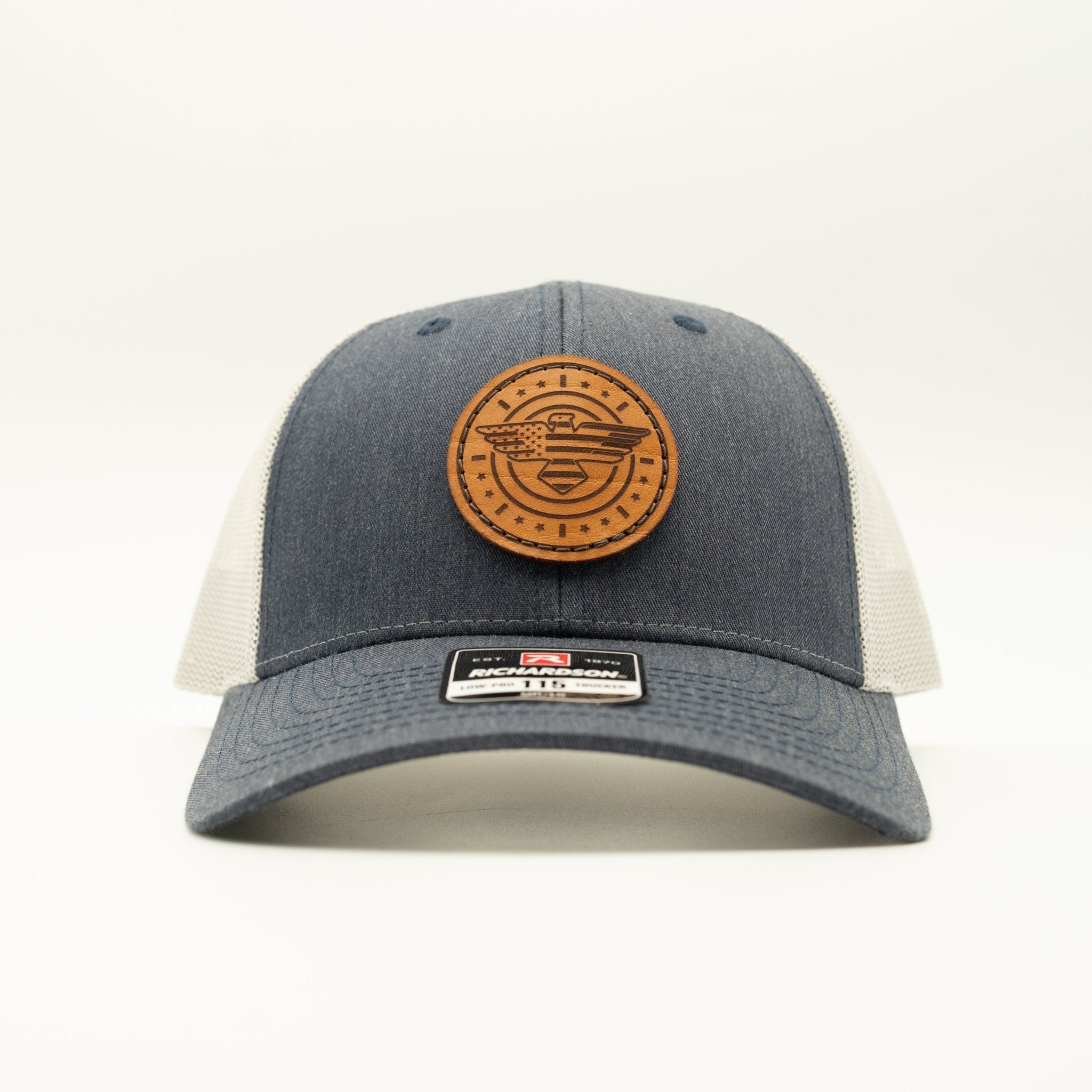 Blue and beige cap with a brown leather patch on a white background
Color: Heather Navy/Grey