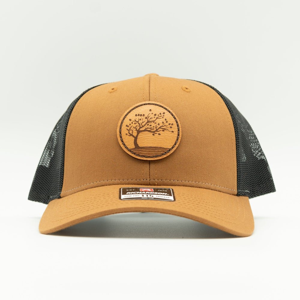 Front view of Carmel Black Blossom leather patch hat, Richardson 115 low profile crown with curved visor for everyday wear.
Color: Caramel/Black