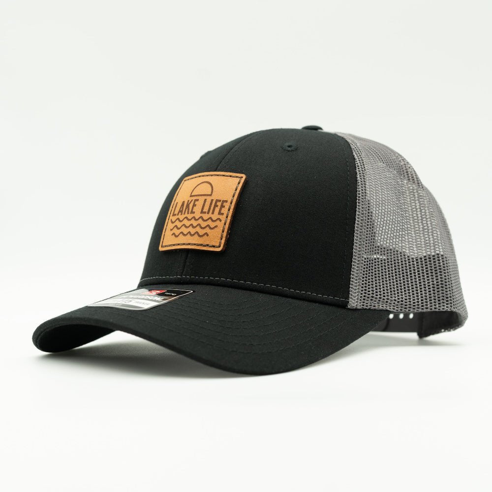 Side view of Lake Life leather patch hat on black and charcoal Richardson 115 low profile cap, showing shallow fit, leather patch, curved bill, and breathable mesh back.
Color: Black/Charcoal