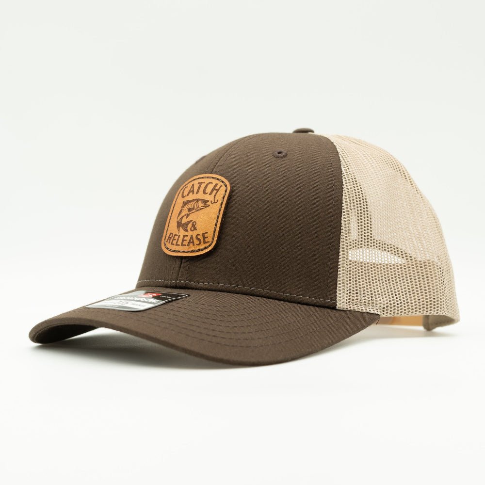 Side view of brown/khaki Richardson 115 low profile leather patch hat with Catch & Release fish design and mesh trucker back.
Color: Brown/Khaki