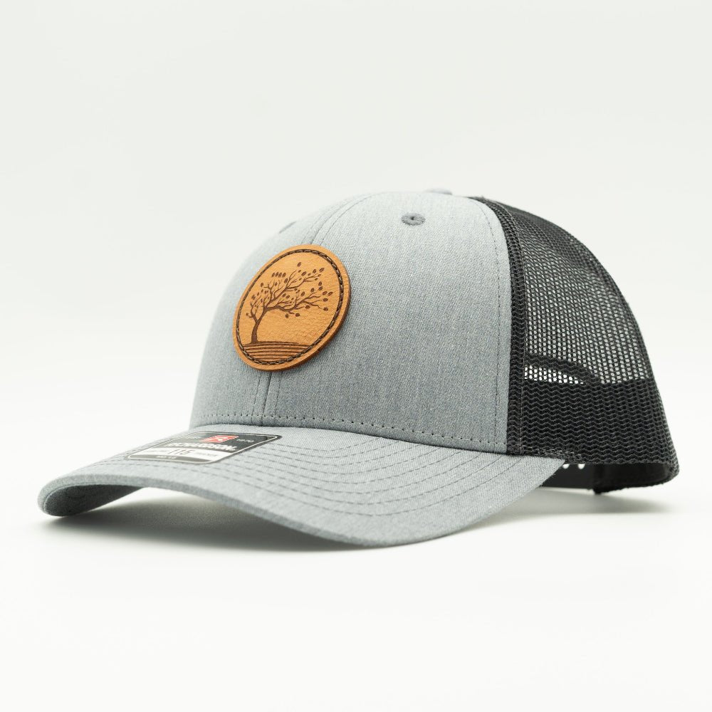 Side profile of Heather Grey Charcoal Richardson 115 low profile hat with Blossom leather patch and grey heather front panel.
Color: Heather Grey/Charcoal