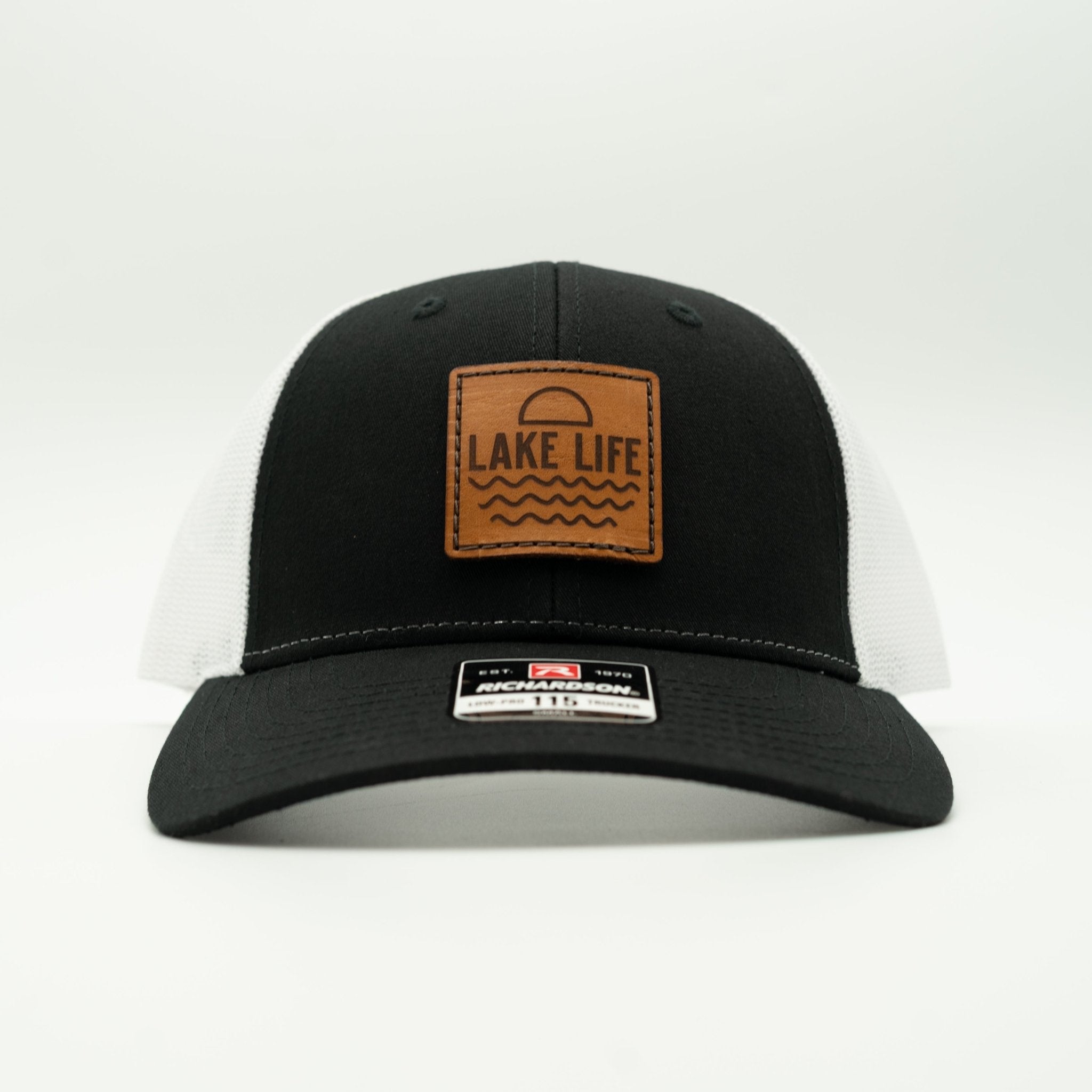 Black cap with a brown 'Lake Life' patch on a white background
Color: Black/White
