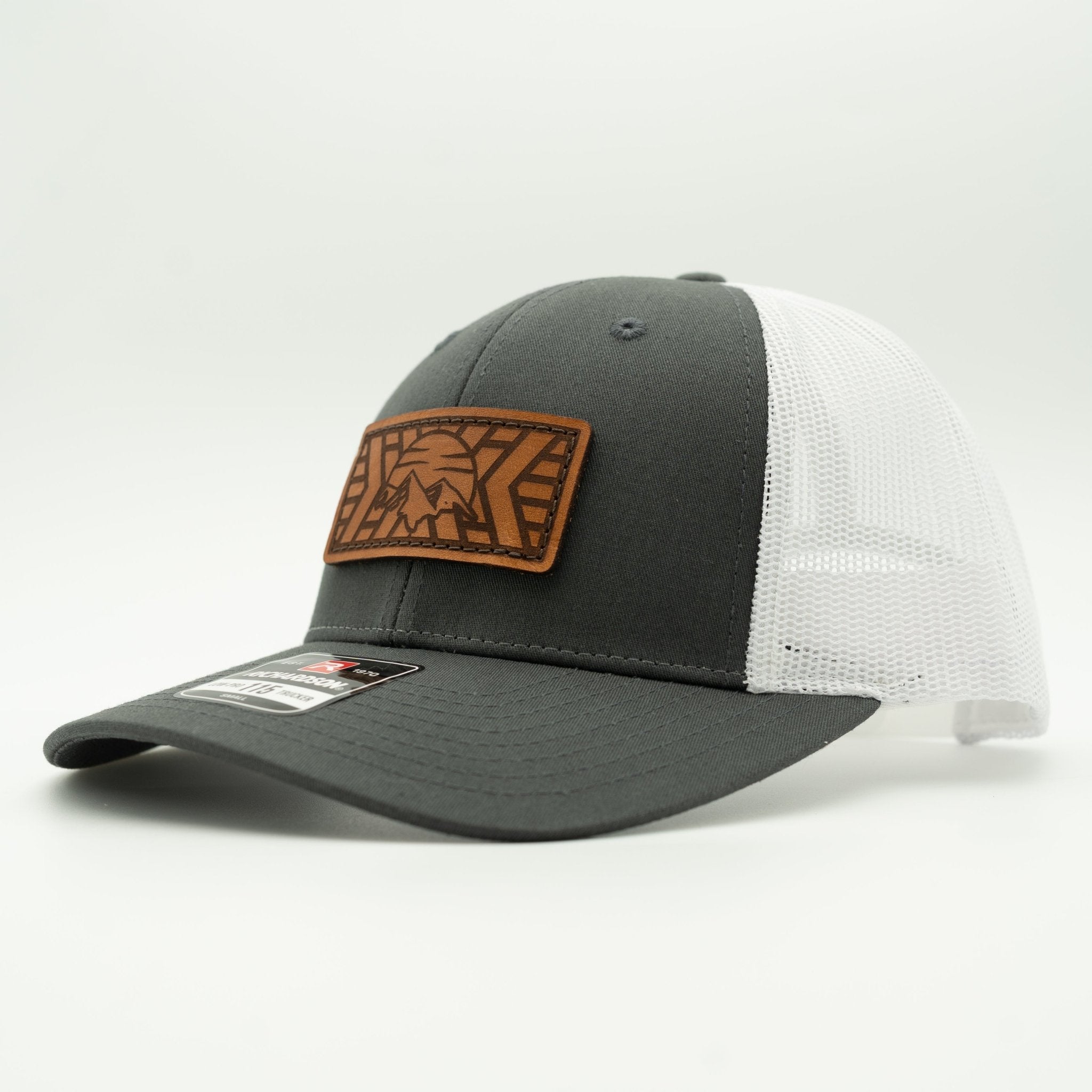 Gray and white cap with a brown leather patch on a light gray background
Color: Charcoal/White