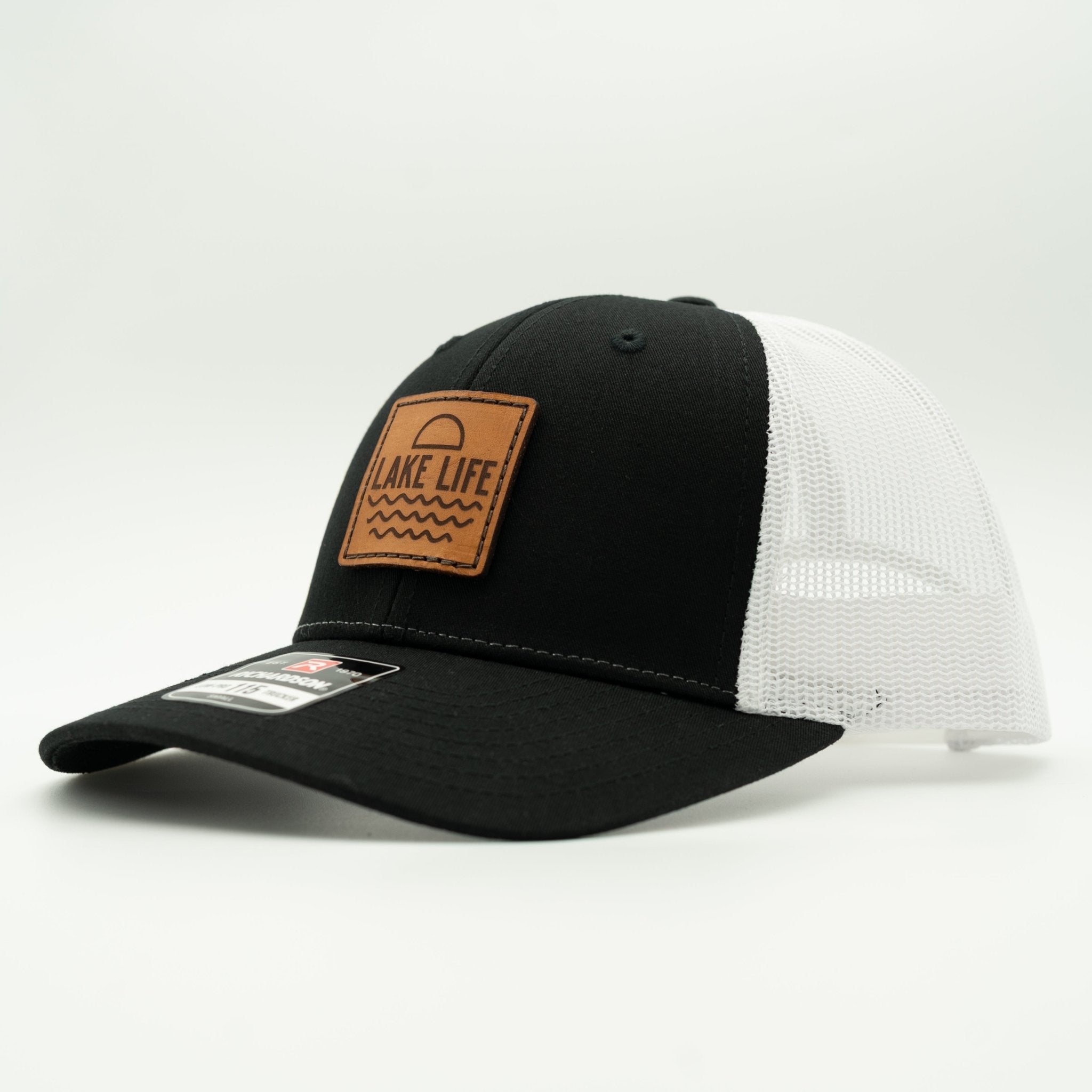 Black and white cap with a leather patch labeled 'Lake Life' on a light gray background
Color: Black/White