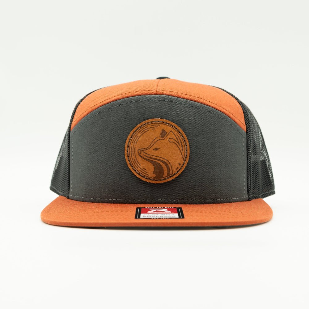Front view of Fox Hollow leather patch hat on charcoal crown with orange bill and black mesh Richardson 168, fox badge on flat brim.
Color: Charc/Orange/Black 168 (OSFM)