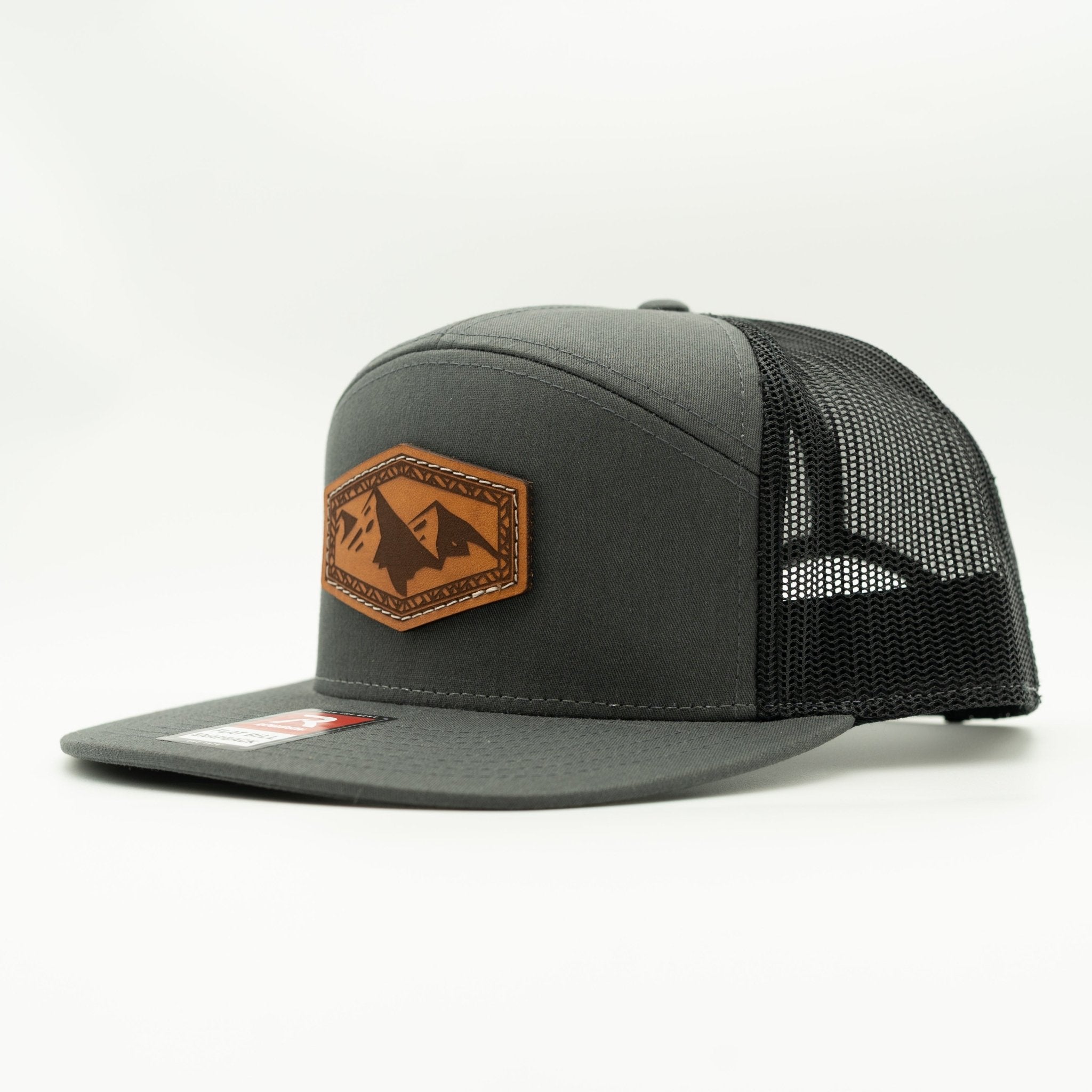Gray trucker cap with brown leather patch on a white background
Color: Charcoal/Black 168 (OSFM)