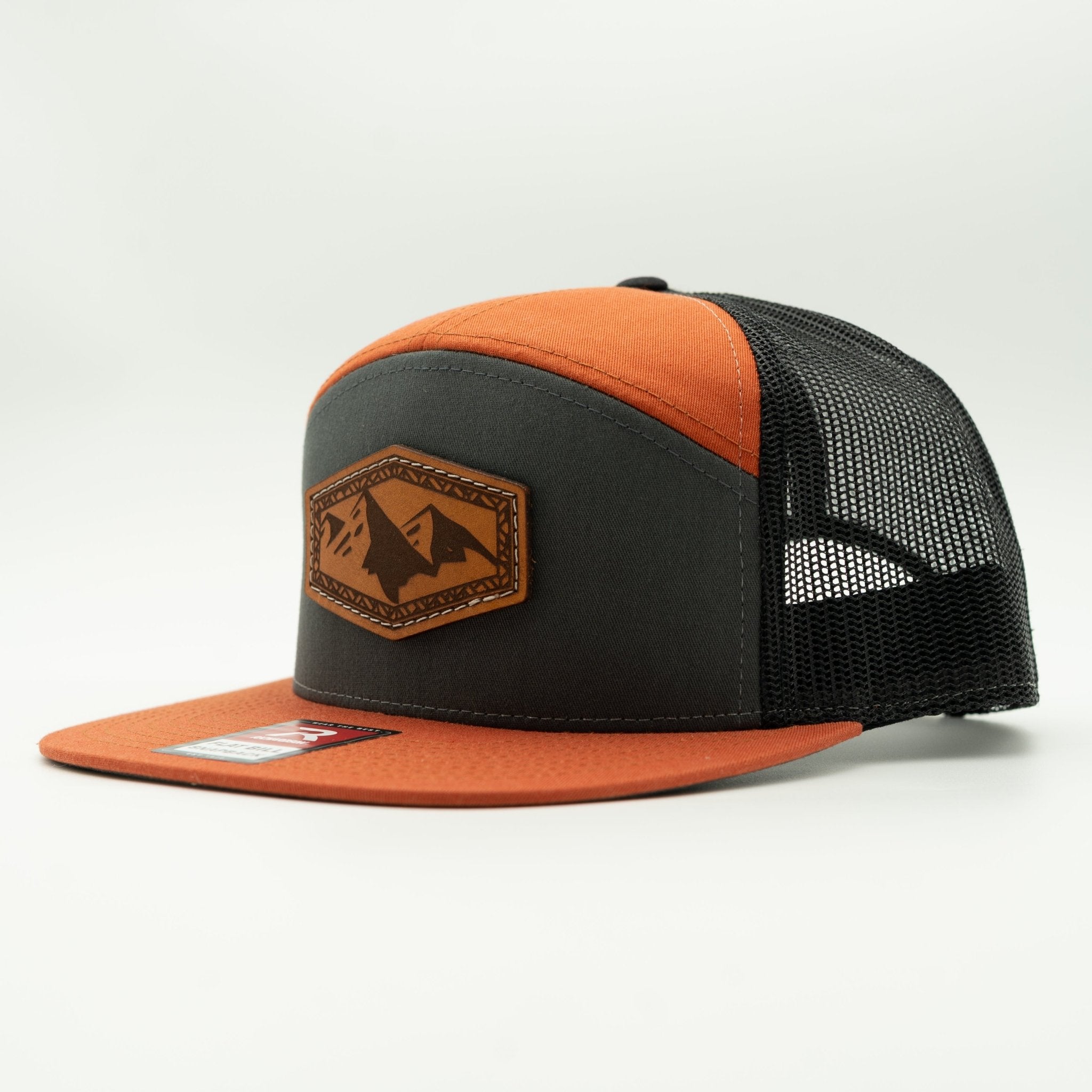 Black and orange cap with a leather patch on a light gray background
Color: Charc/Orange/Black 168 (OSFM)
