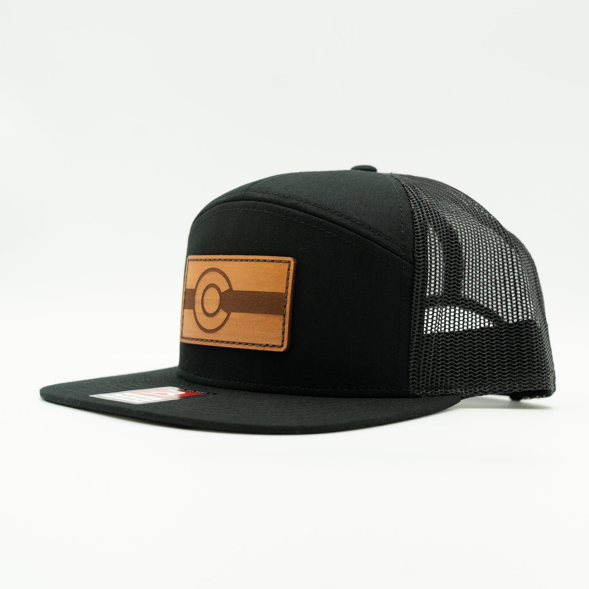 Side view of solid black Richardson 168 flat bill trucker hat with light brown leather Colorado flag patch, Colorful Colorado leather patch hat
Color: Black/Black 168 (OSFM)