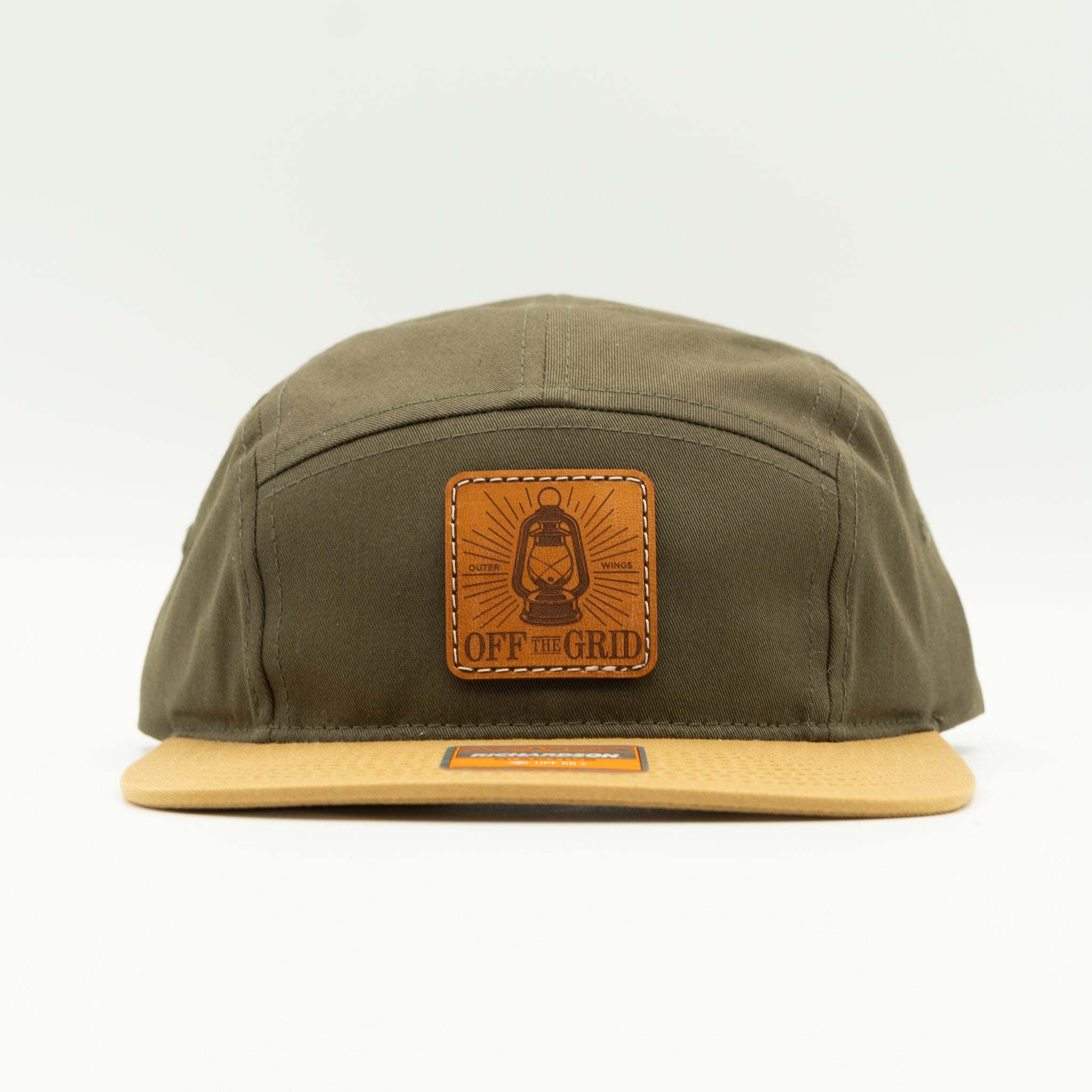 Loden biscuit Off The Grid leather patch camper hat front view, Richardson 217 five panel with engraved patch and flat bill.