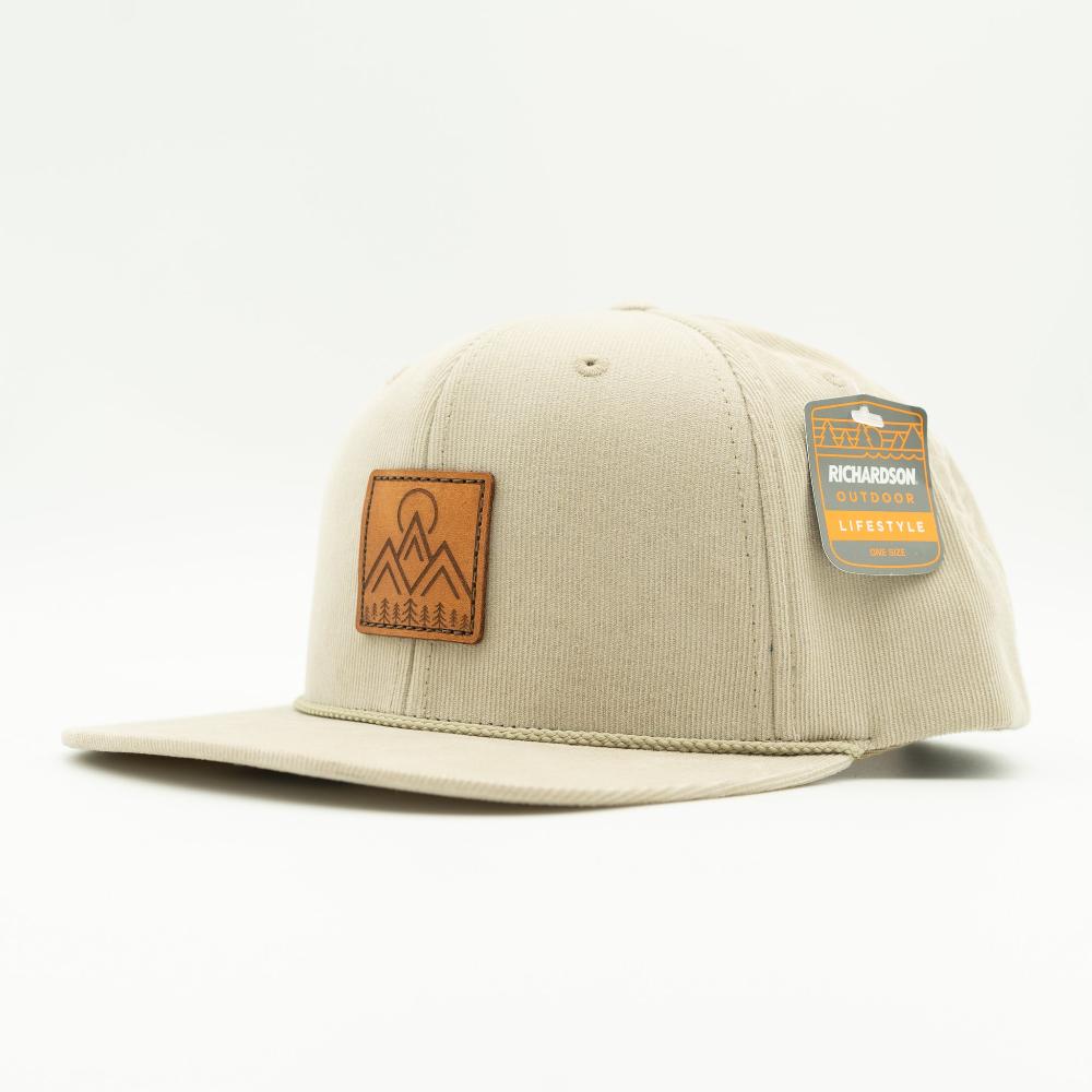 Side view of tan Richardson 253 Moonlite Mountain corduroy rope hat, highlighting the stitched leather mountain patch, flat bill, and high-profile crown.