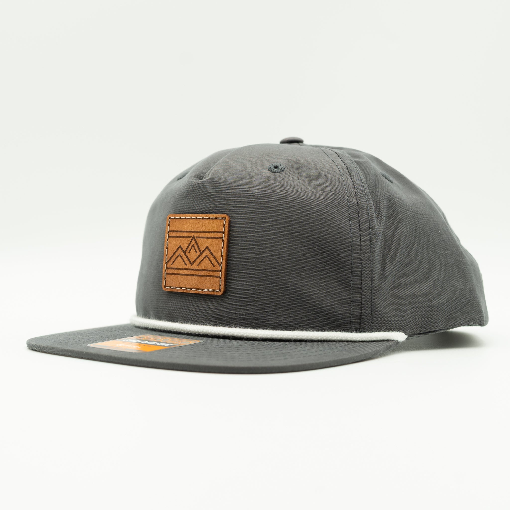 Rustic Ridge charcoal and white Richardson 256 rope hat side view, grey crown, white back, and contrast leather mountain patch.