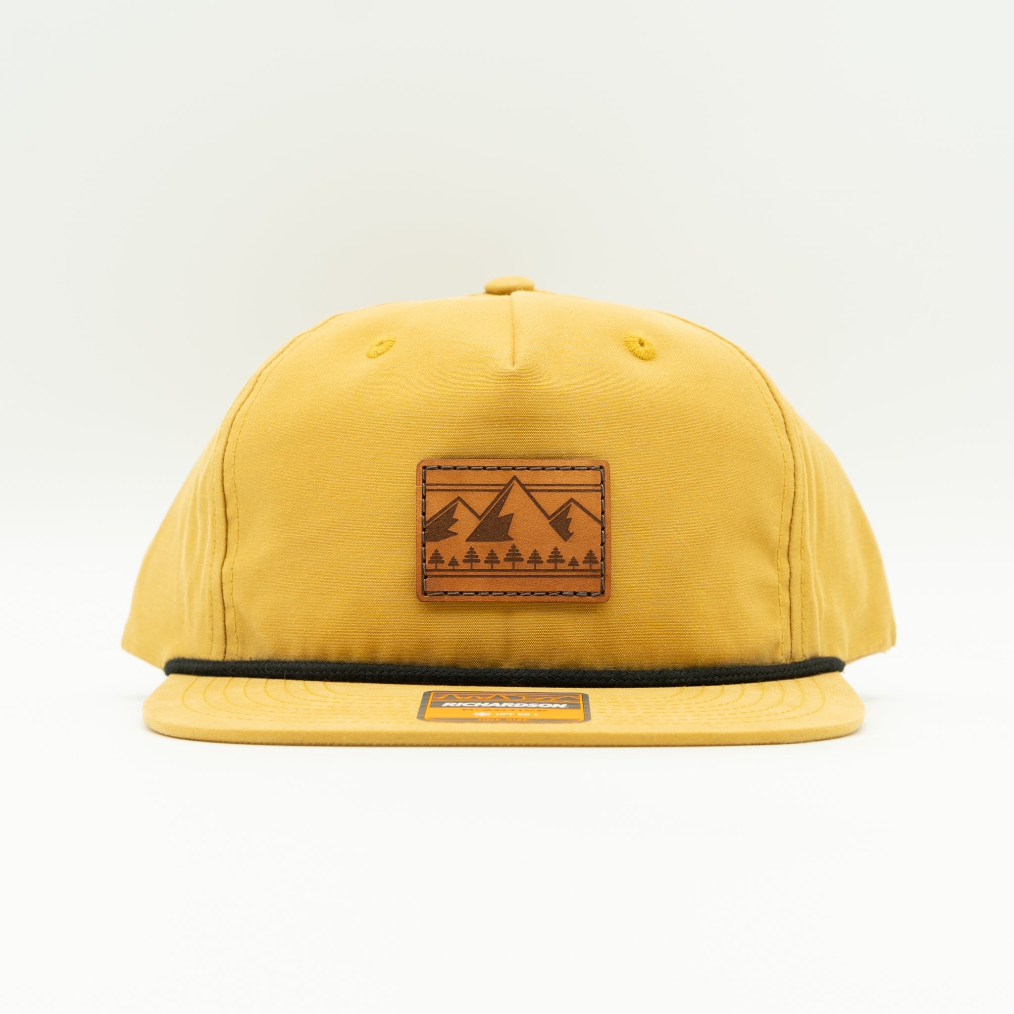 Front view of biscuit Richardson 256 Ridgeline rope hat with square leather mountain patch, flat bill with rope accent, UPF 50+ low profile mountain hat.