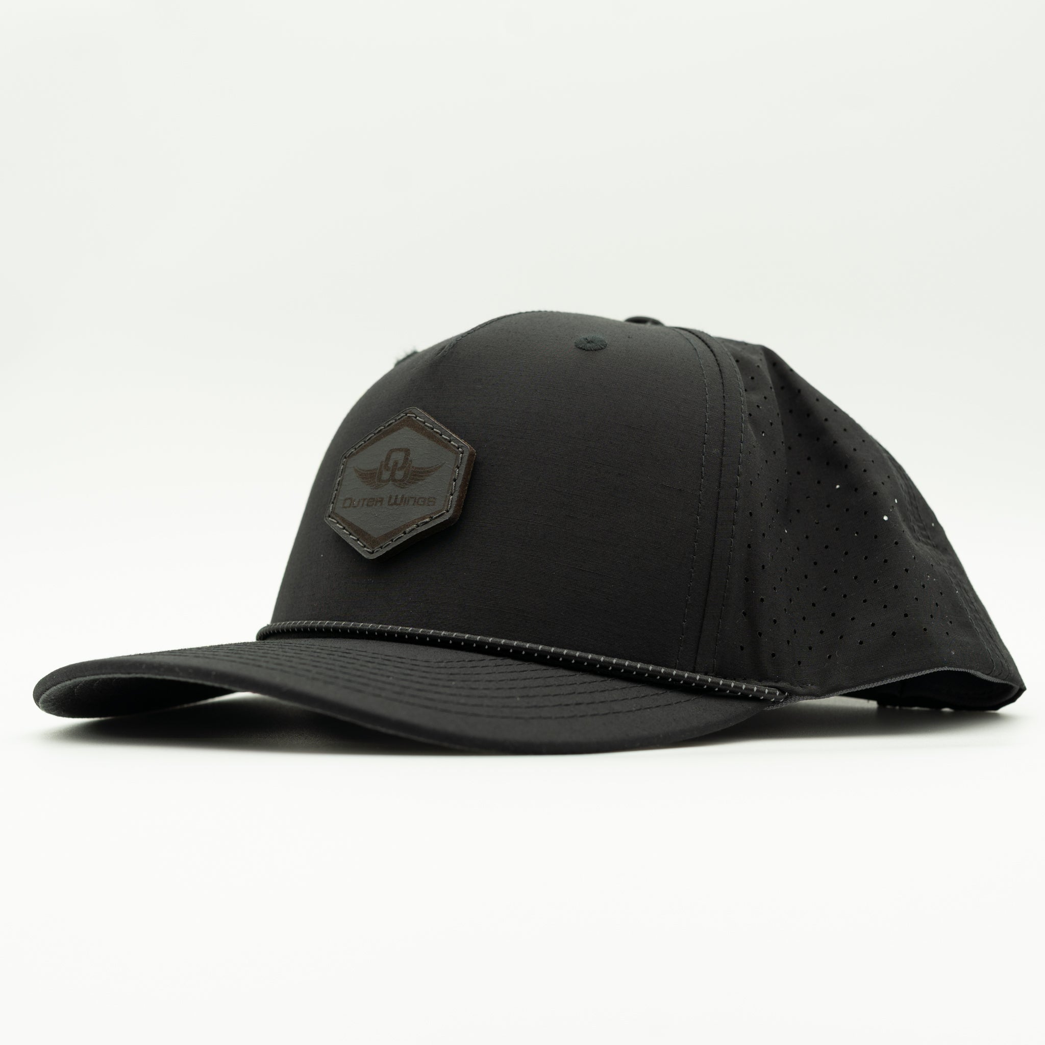 A black baseball cap with a structured crown, perforated side panels, a curved brim, and a Black hexagonal patch on the front featuring the brand name 'Outer Wings'.
Color: Black