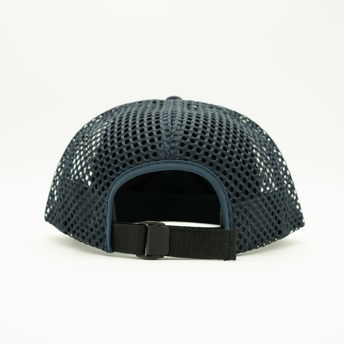 A dark navy blue mesh baseball cap viewed from the back, featuring a black adjustable strap with a plastic buckle.
Color: Navy/Navy