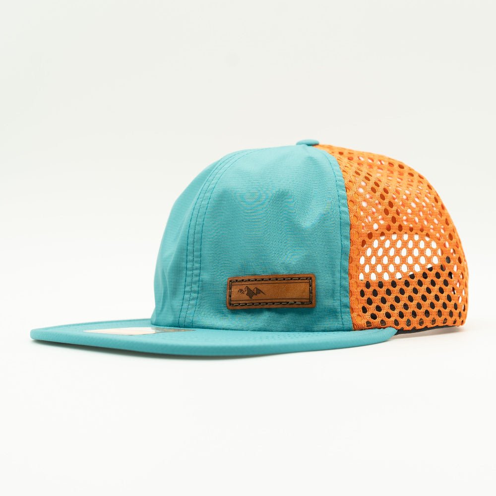 Side view of Richardson 935 hat in teal/orange, emphasizing the hat’s lightweight, water-resistant properties.
Color: Teal/Orange