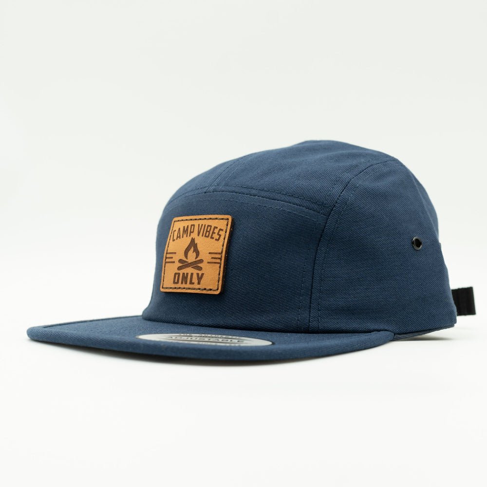 Side angle of navy Camp Vibes Only leather patch camper hat, highlighting the flat bill and mesh-free low profile 5 panel fit.
Color: Navy