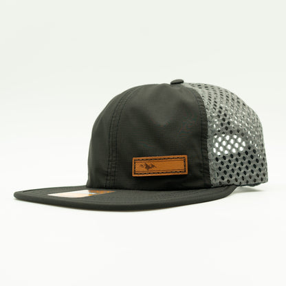 Side view of Richardson 935 hat in black/charcoal, highlighting the Active Mountain leather patch and adjustable backstrap.