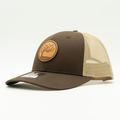 Side view of the Blossom Leather Patch Hat by Outer Wings in brown/khaki, showing the hat’s structured low-profile fit and adjustable SnapBack closure. The detailed Blossom leather patch is hand-sewn for durability and style.