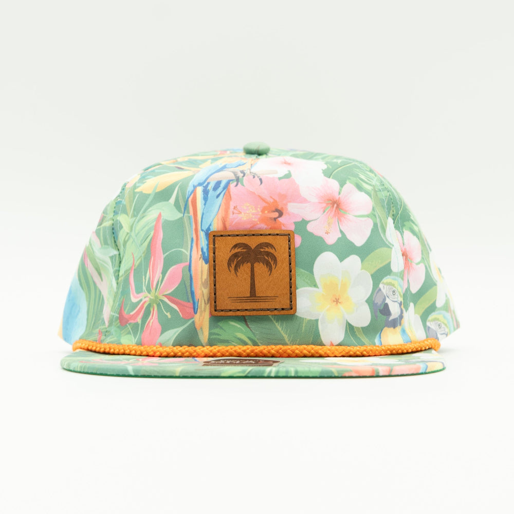 Front view of the Island Breeze Hat in Hawaiian Rainforest, highlighting the unique rainforest-themed print, structured profile, and classic rope detail. The hat includes a genuine leather patch with a palm tree engraving and an adjustable leather strap for a custom fit.