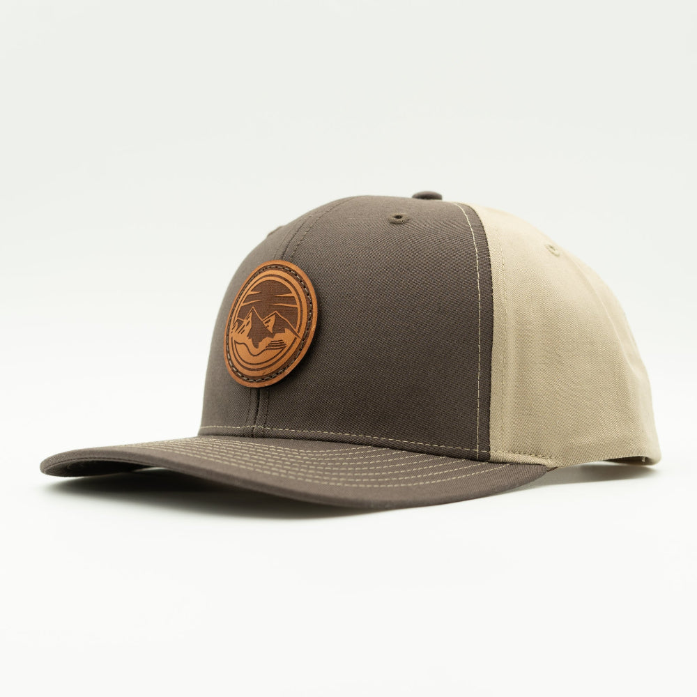 Side view of the Mountain Lake leather patch hat on Richardson 312 in Brown/Khaki, highlighting the pre-curved visor, adjustable snapback, and seamless front panel. A rugged, stylish choice for outdoor adventures.