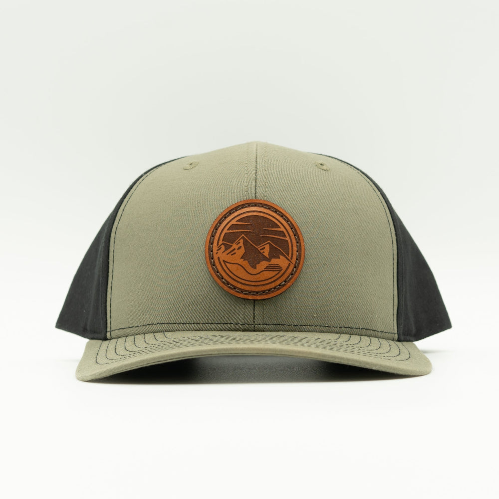 Front view of the Mountain Lake leather patch hat on Richardson 312 in Loden/Black, featuring a six-panel, mid-profile design with a leather patch combining rugged outdoor themes. Perfect for those seeking high-quality Colorado hats.