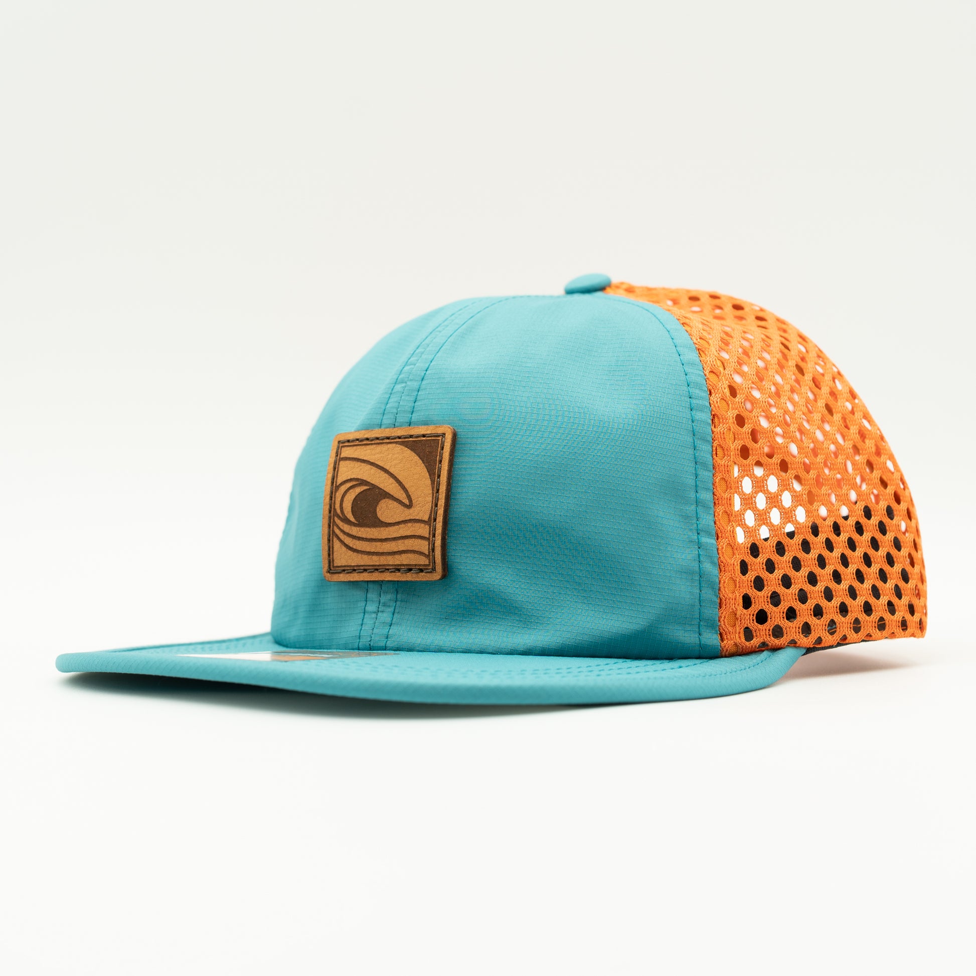 Side view of the Ocean Swell Hat by Outer Wings in Teal/Orange, showing the wide-set mesh back, adjustable backstrap, and flexible visor. A lightweight, breathable outdoors hat for any adventure.