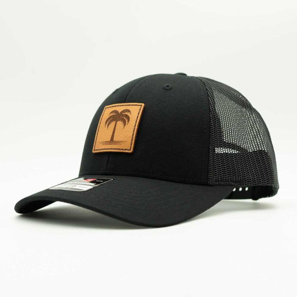 Side view of the Solo Palm Leather Patch Hat by Outer Wings in Black/Black, highlighting the breathable mesh back, structured profile, and adjustable SnapBack closure. A durable and stylish custom leather patch hat for outdoor and casual wear.