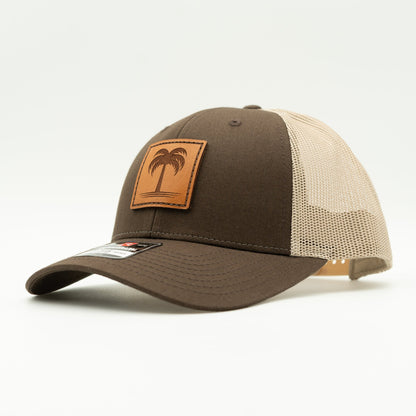 Side view of the Solo Palm Leather Patch Hat by Outer Wings in Brown/Khaki, highlighting the mesh back, adjustable SnapBack, and structured profile. A rugged yet stylish custom leather patch hat for all your outdoor activities.