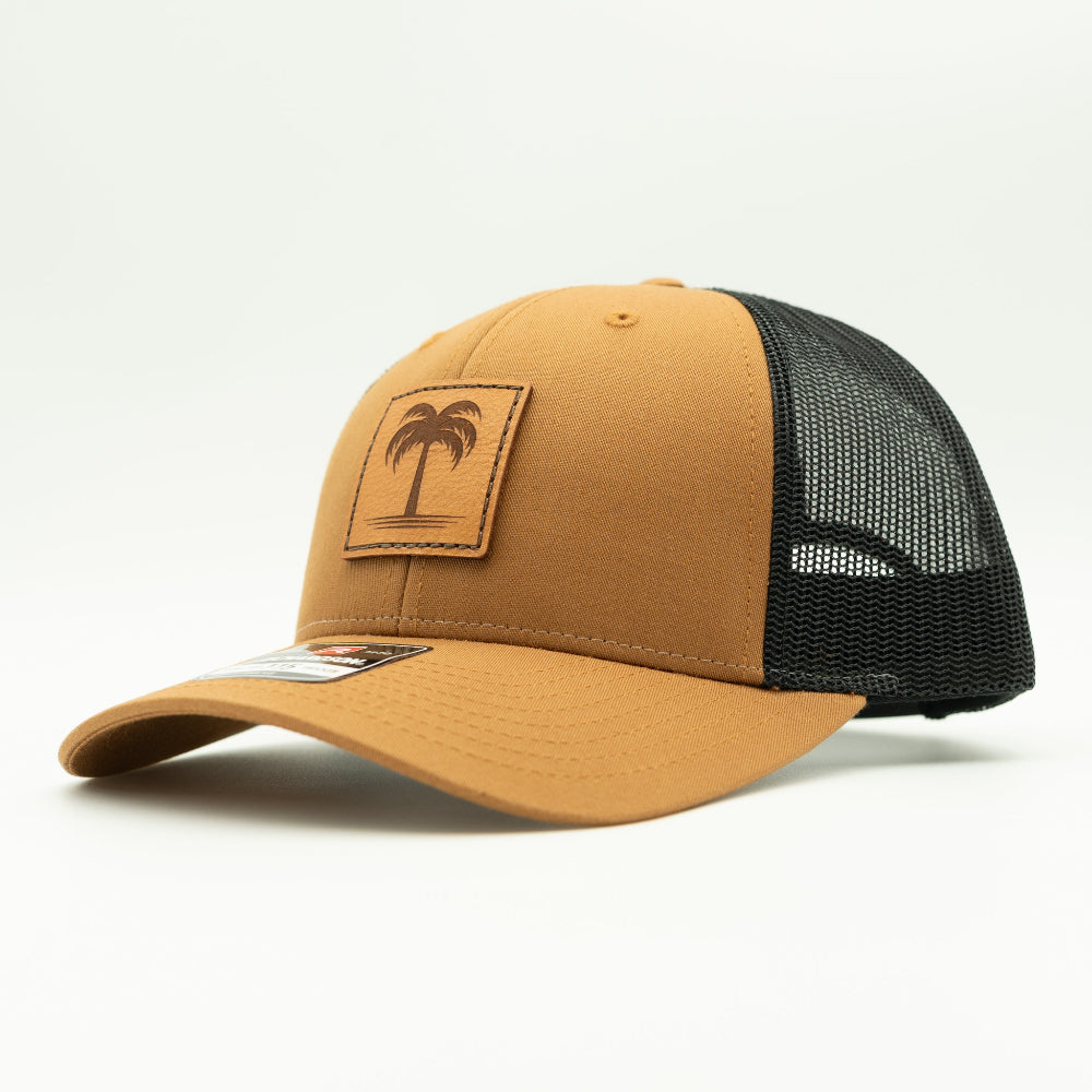 Side view of the Solo Palm Leather Patch Hat by Outer Wings in Caramel/Black, highlighting the structured profile, breathable mesh back, and adjustable SnapBack closure. A stylish and durable custom leather patch hat for casual and outdoor wear.