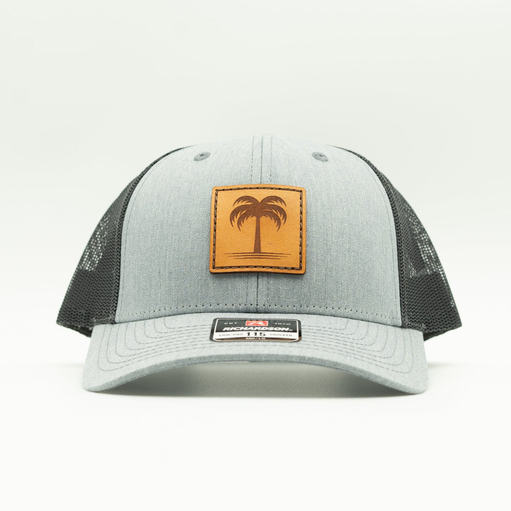 Front view of the Solo Palm Leather Patch Hat by Outer Wings in Heather Grey/Charcoal, highlighting the breathable mesh back, adjustable SnapBack, and structured profile. A durable and stylish custom leather patch hat for all-day wear.